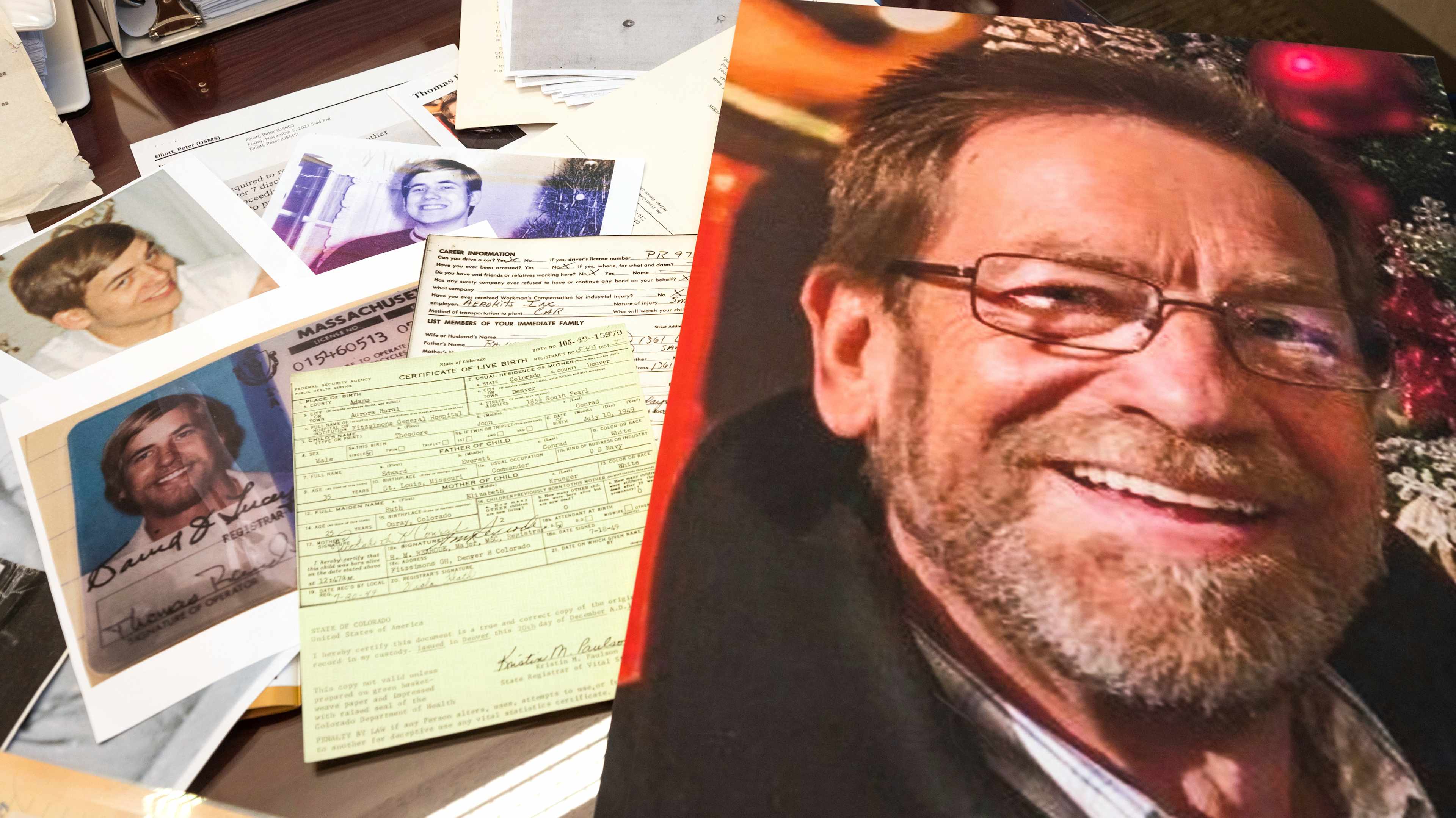 Photos, a driver's license, the original warrant and other items from a 1969 robbery involving Ted Conrad are shown on Dec. 16, 2021 at the Carl B. Stokes U.S. Courthouse in Cleveland.