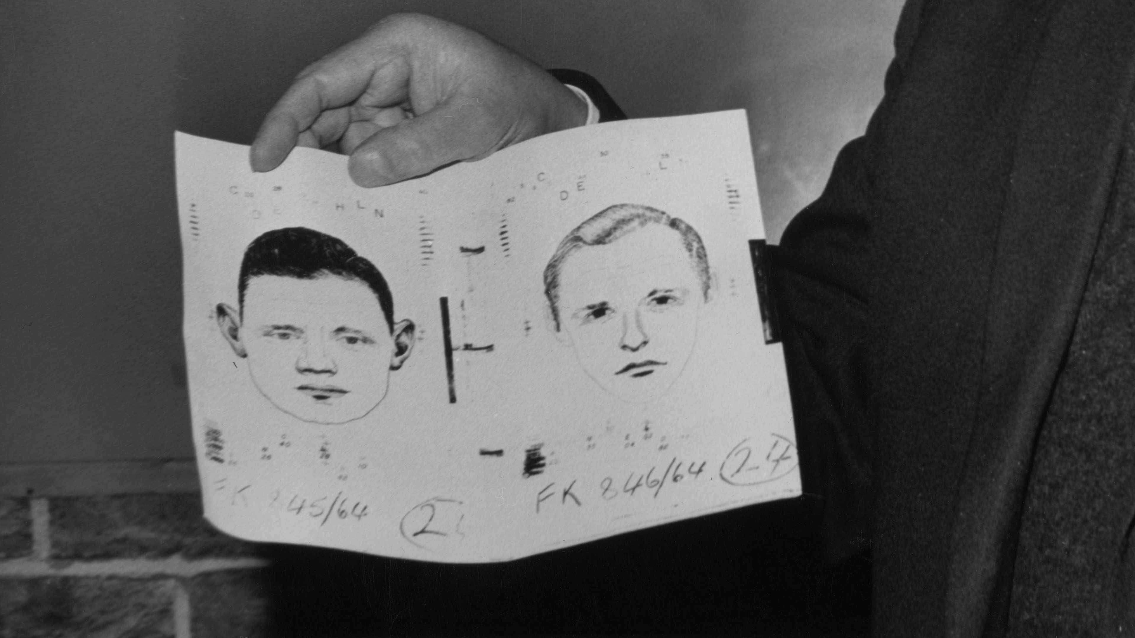 Officer Detective Superintendent William Marchant holds an identikit picture of the two men police want to interview in relation to the murder of prostitute Margaret McGowan in 1964.