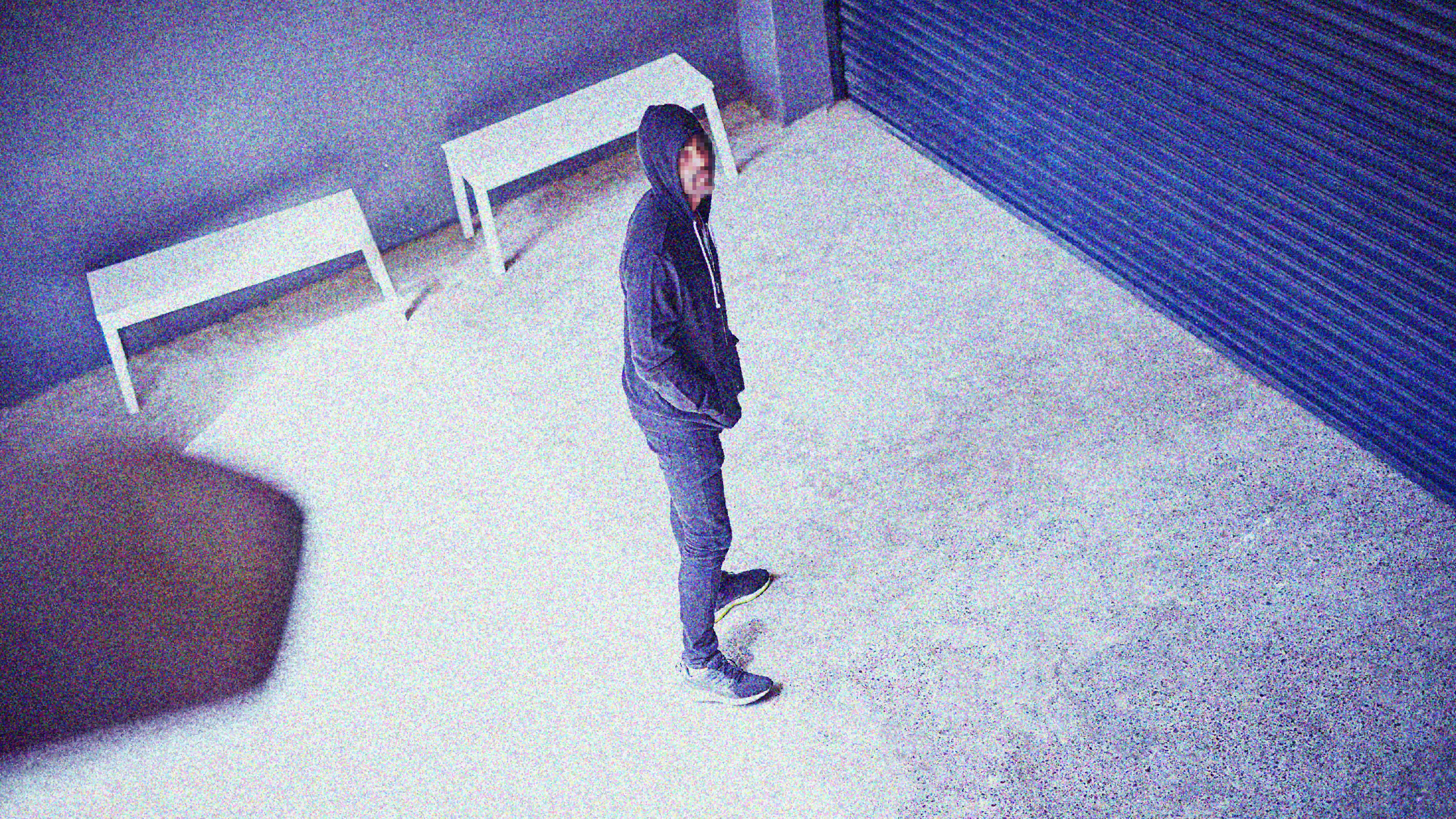 Man viewed on camera standing outside a building