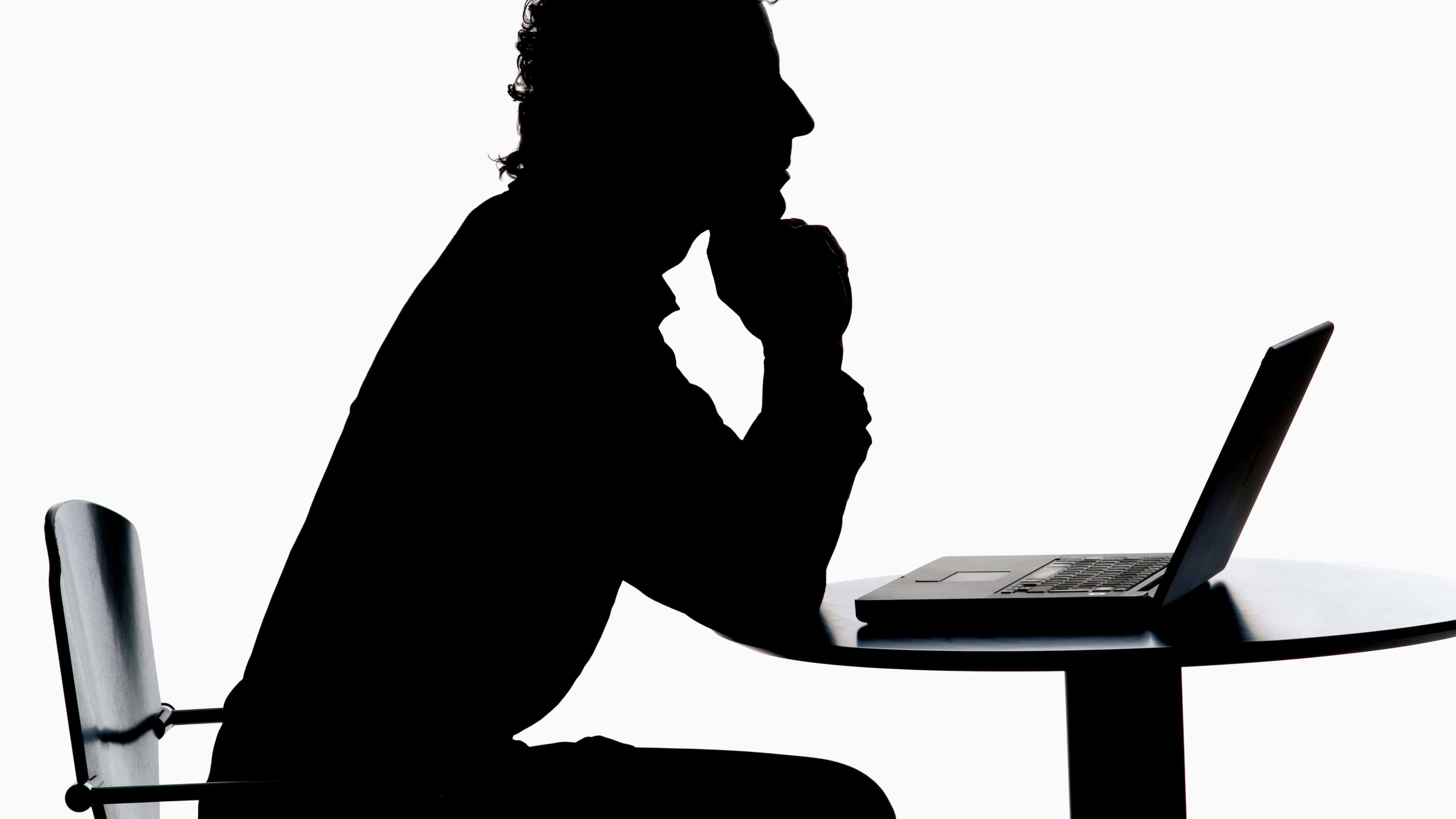 Man working on laptop, silhouette
