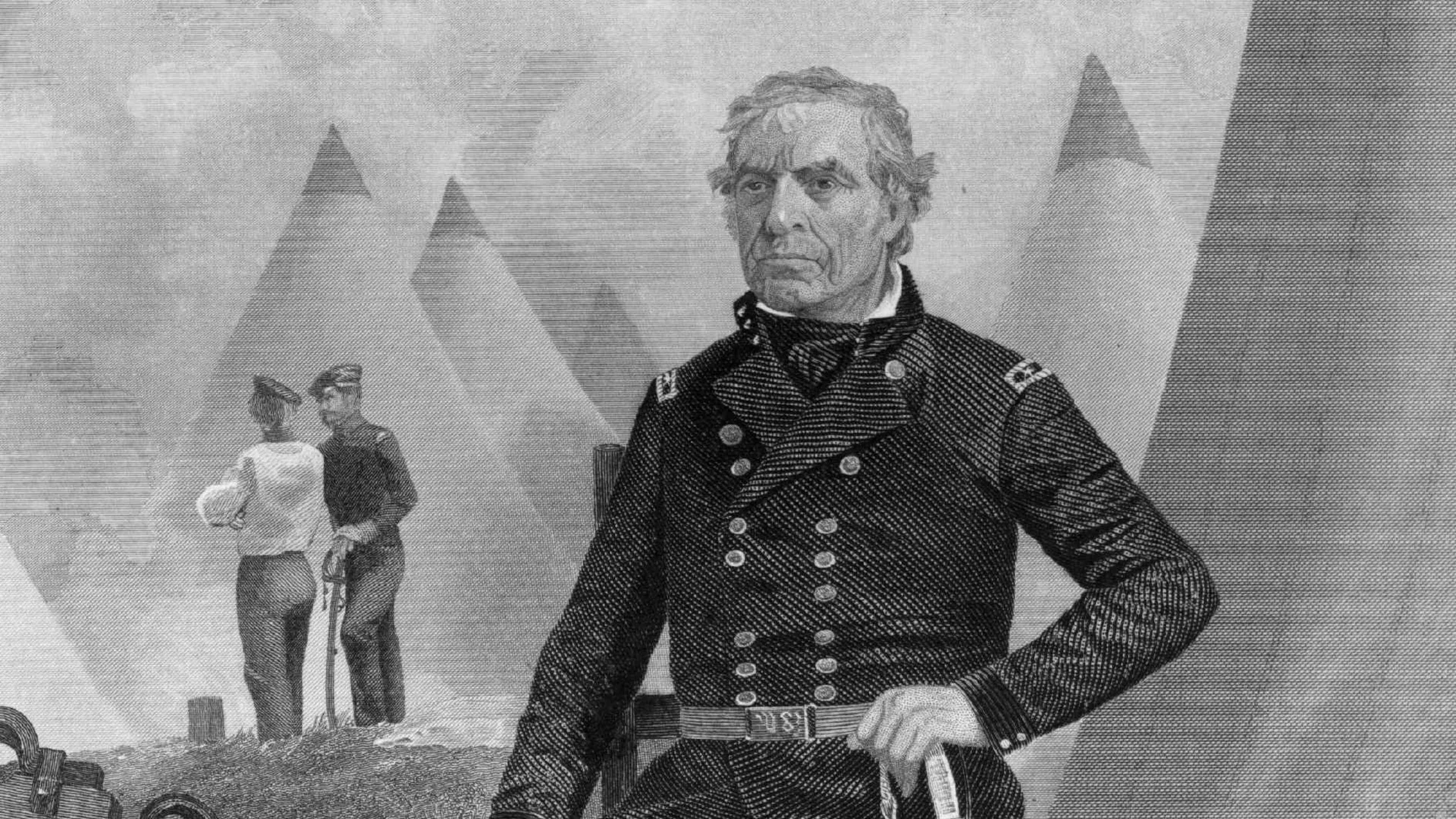 The image depicts a portrait of a man in military uniform, seated in a field with pyramids visible in the background.