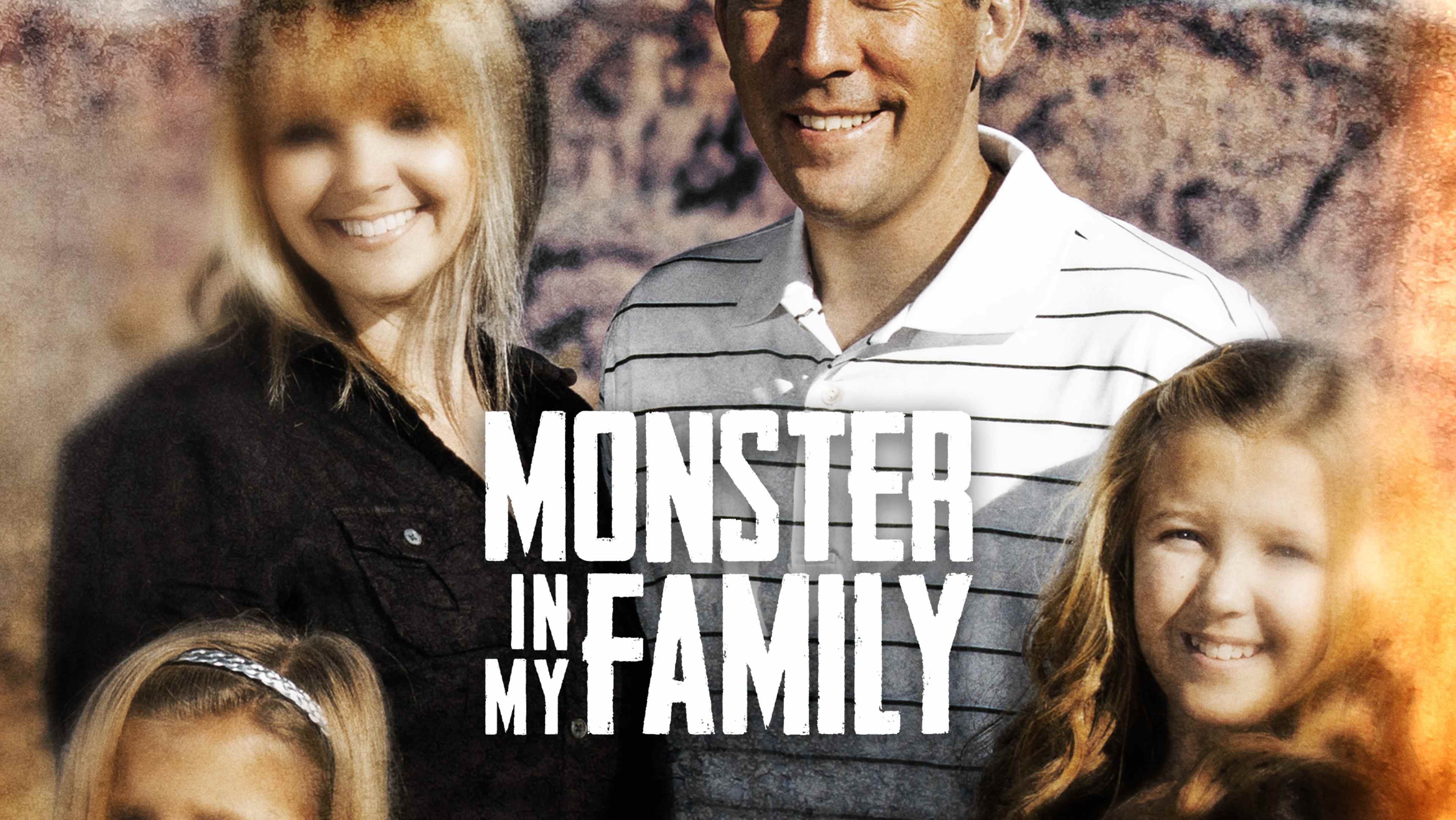 The image shows a smiling family of three - a man, a woman, and a young girl - posing together in front of a blurred natural background.
