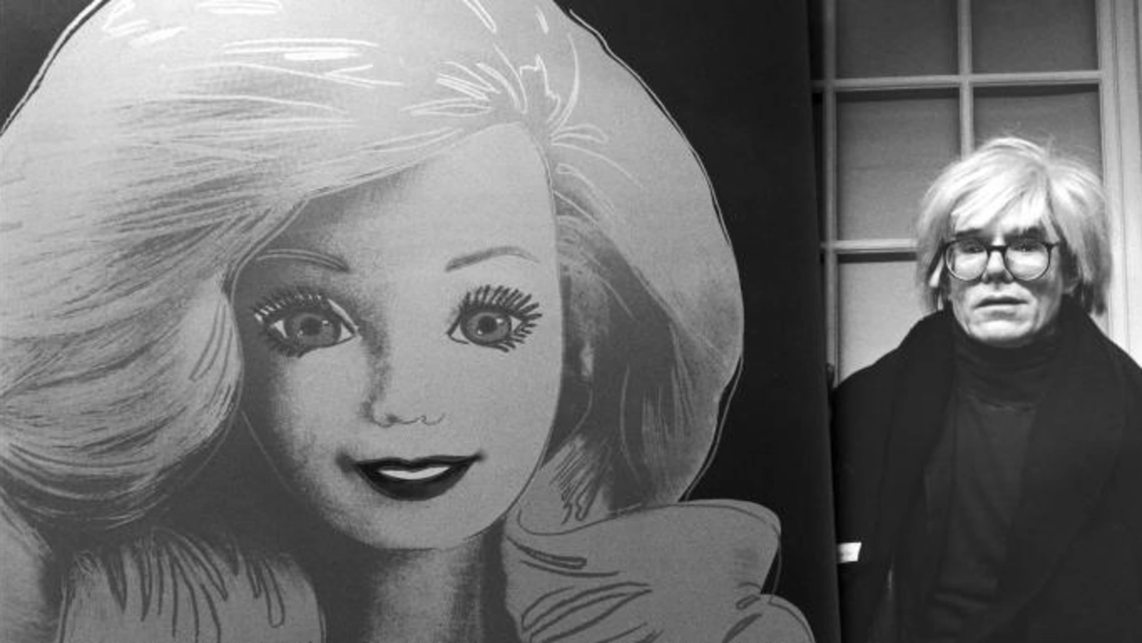 Artist Andy Warhol displaying his portrait of a Barbie doll.  (Credit: DMI/The LIFE Picture Collection/Getty Images)
