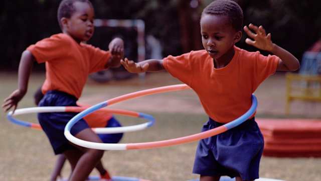 Schoolboys Playing with Hula Hoop - stock photo