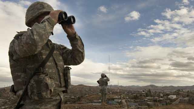 Members of the US Army National Guard keep watch along the US Mexico border in Nogales, Arizona, 2010. (Credit: Nikki Kahn/The Washington Post via Getty Images)