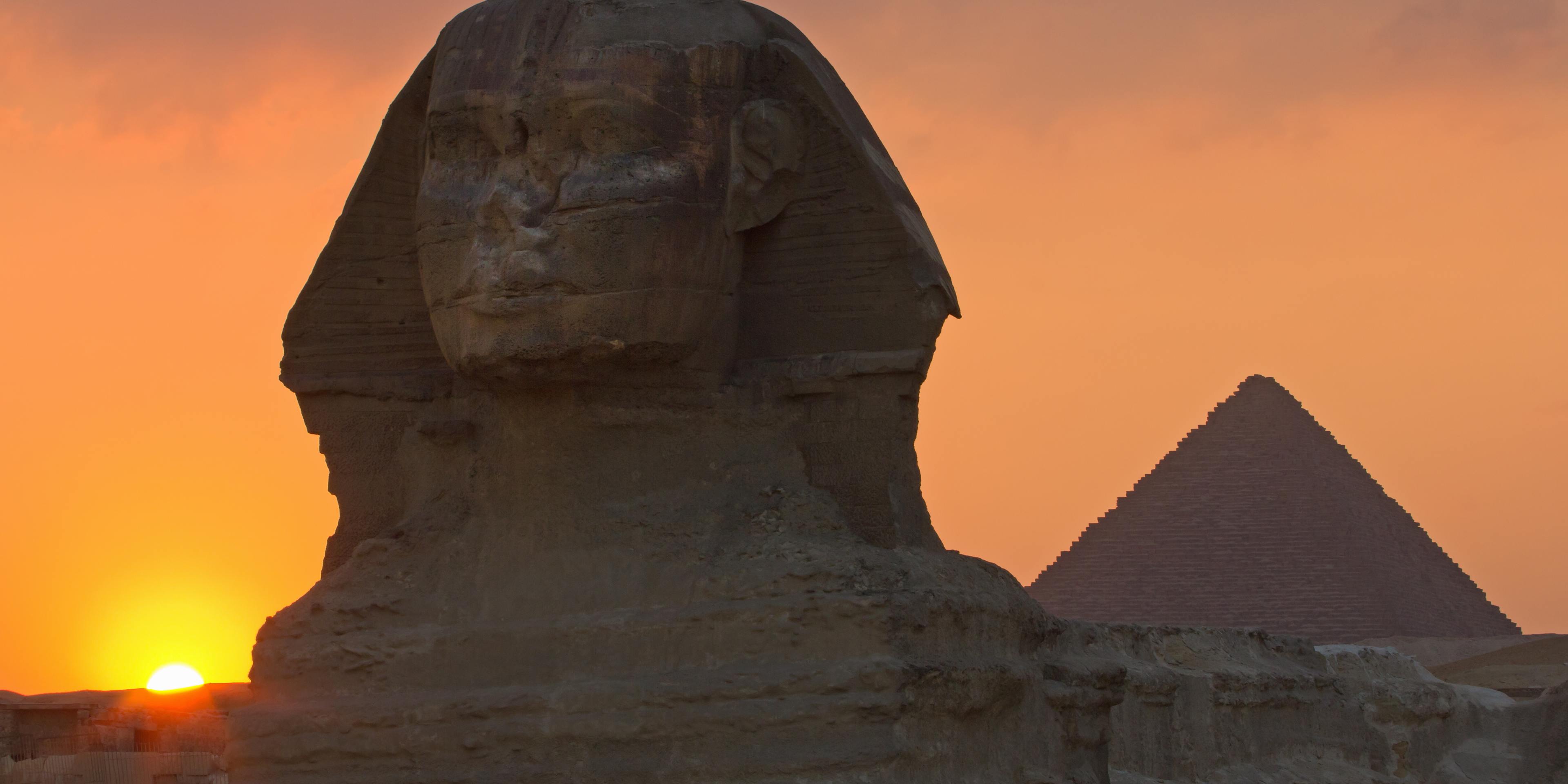 The Sphinx and a pyramid (Pyramid of Menkaure) at sunset.