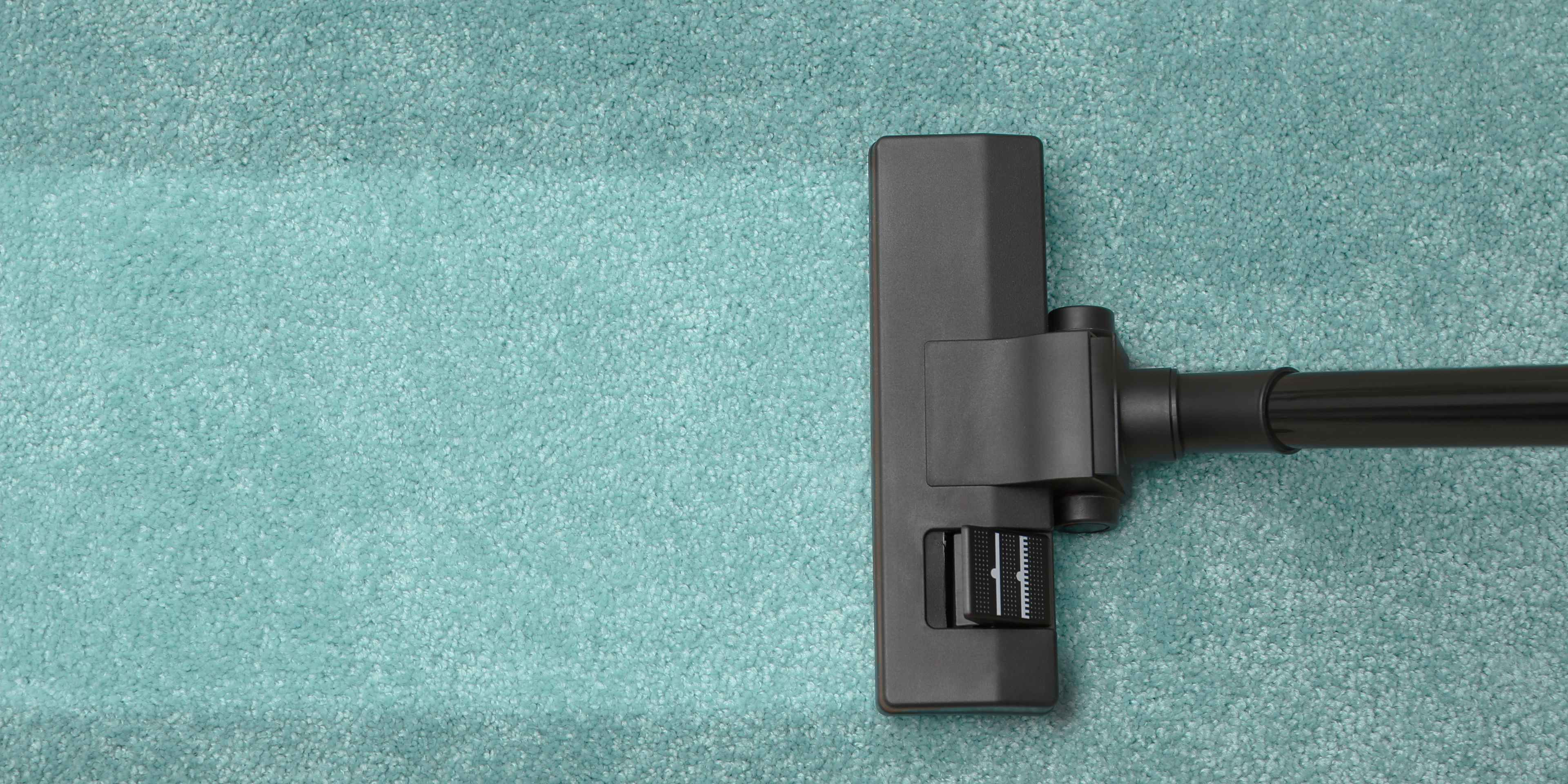Vacuum cleaning a carpet.
