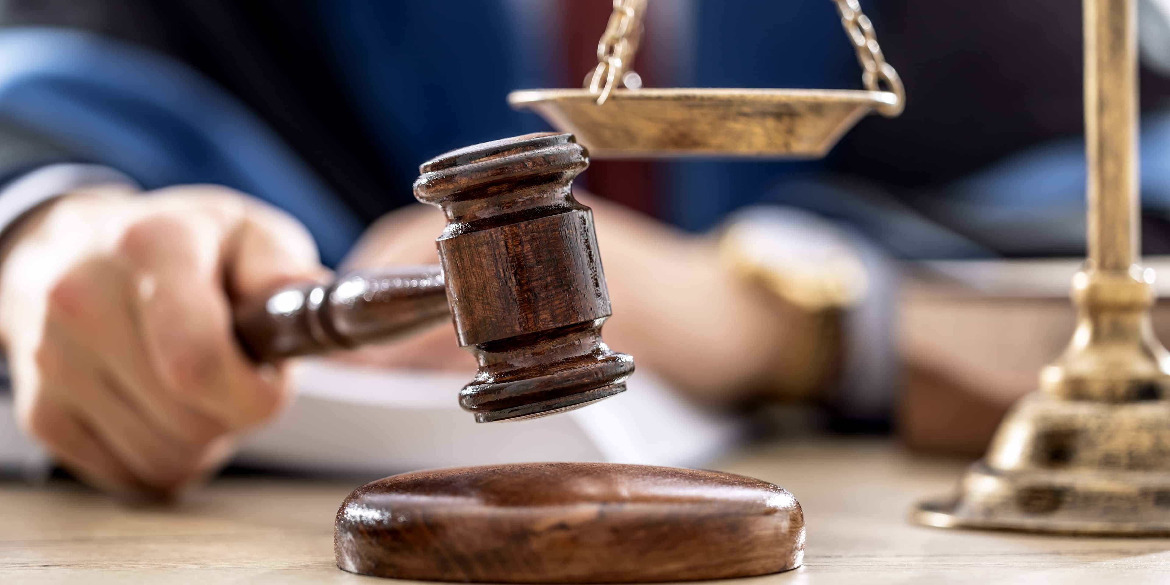 Symbols of law a legal system - a judge, gavel and scales representing jurisdiction.