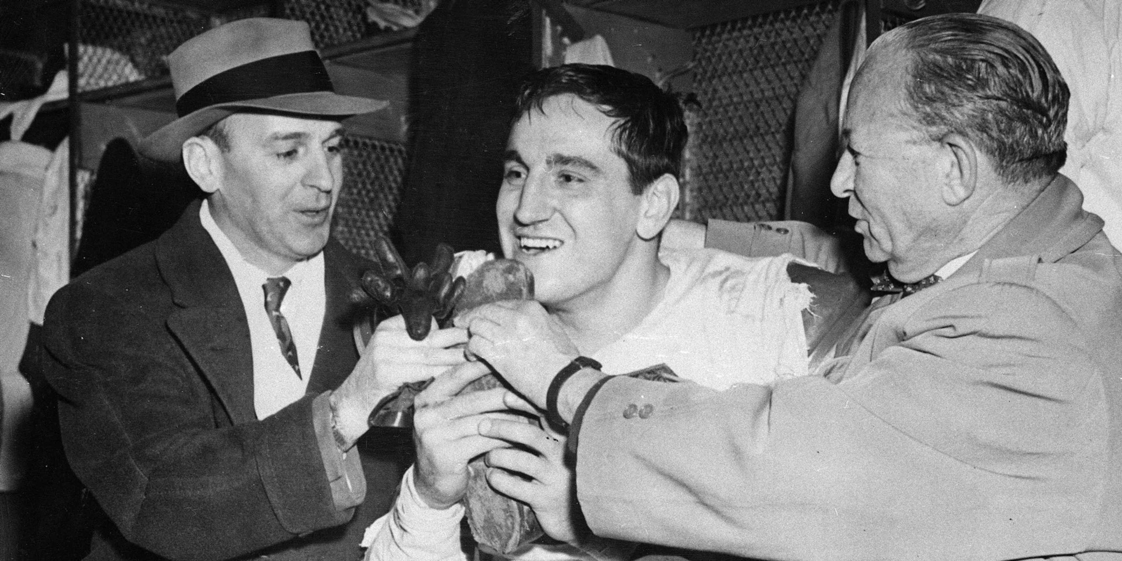 Lou Groza (center) hugs the shoe he used to kick the winning field in the 1950 NFL Championship Game