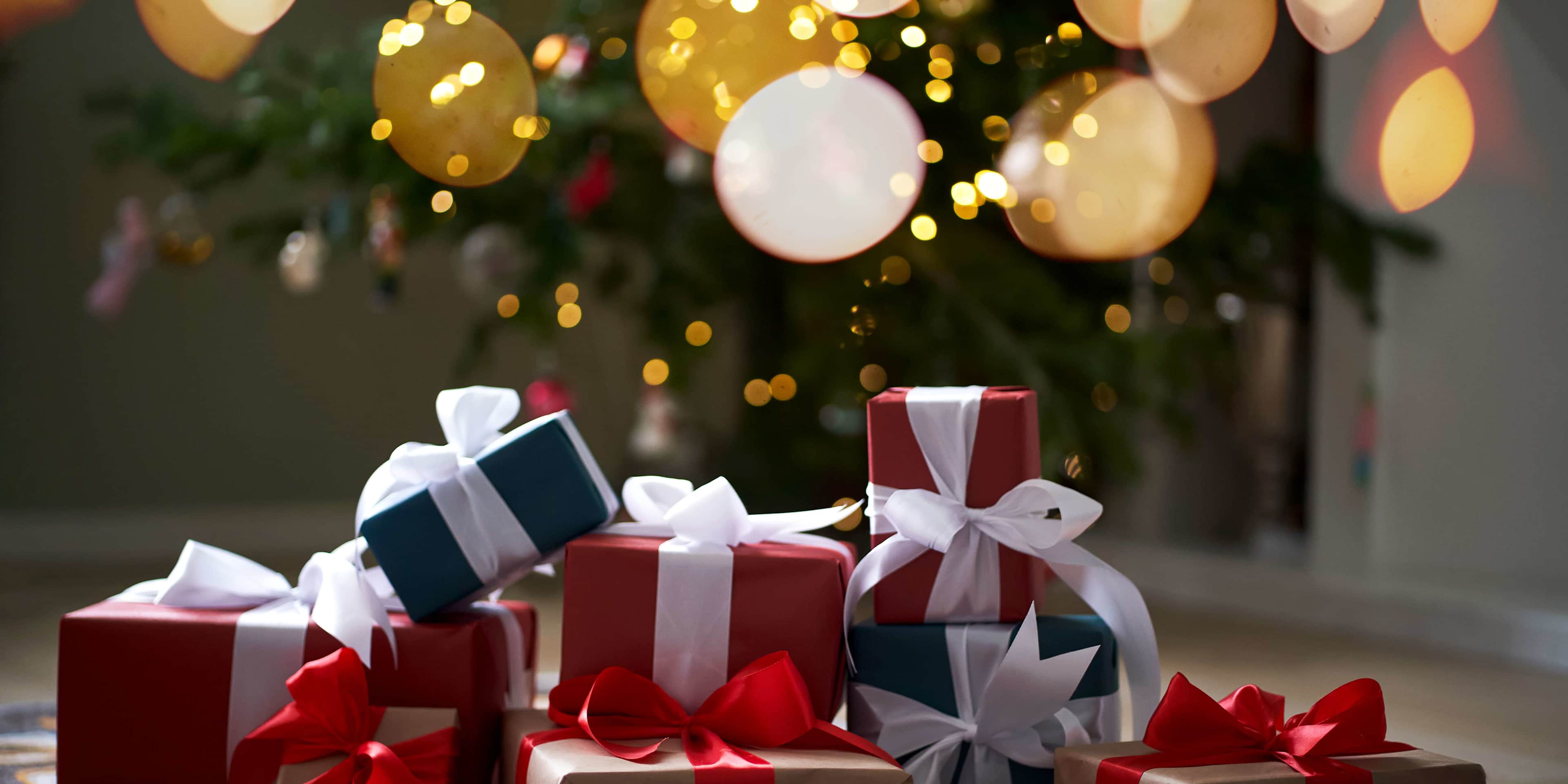 Lots of Christmas presents under the decorated Christmas tree.