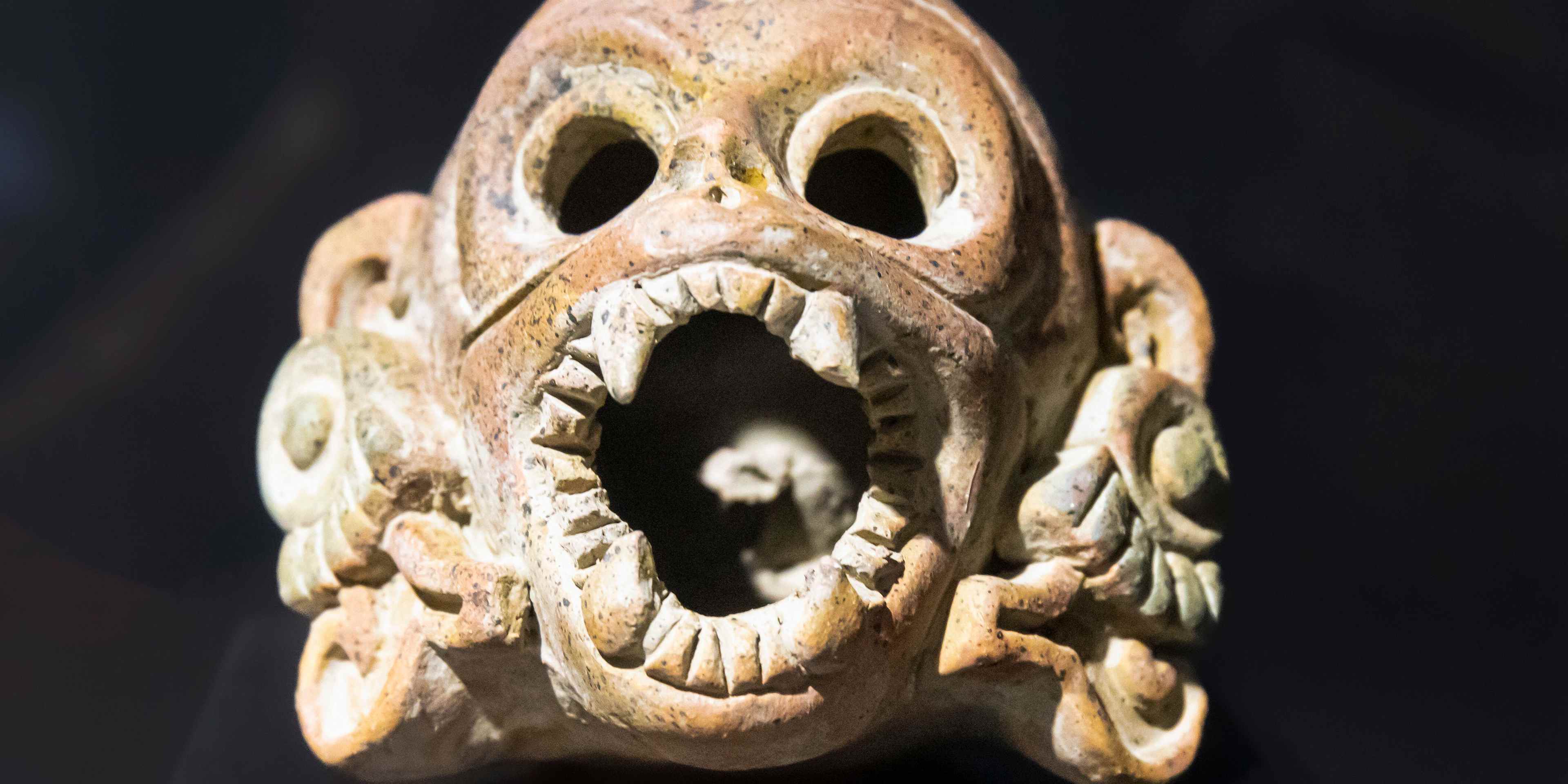 An Aztec death whistle in the shape of a human skull.  When blown, a death whistle emits a realistic shriek, or scream.
