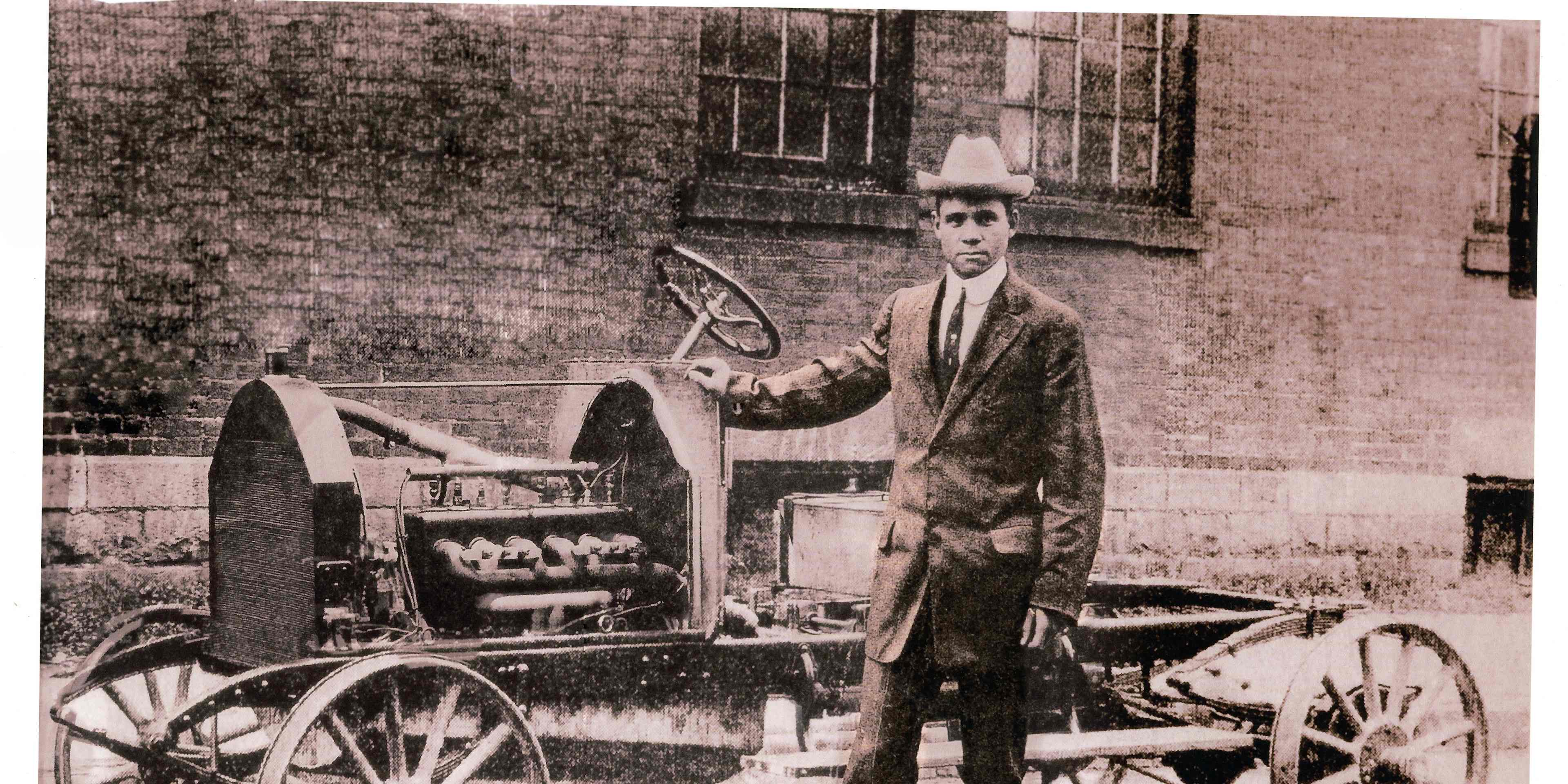Frederick Patterson standing beside a bare Patterson-Greenfield automobile chassis, probably for a larger touring car body.