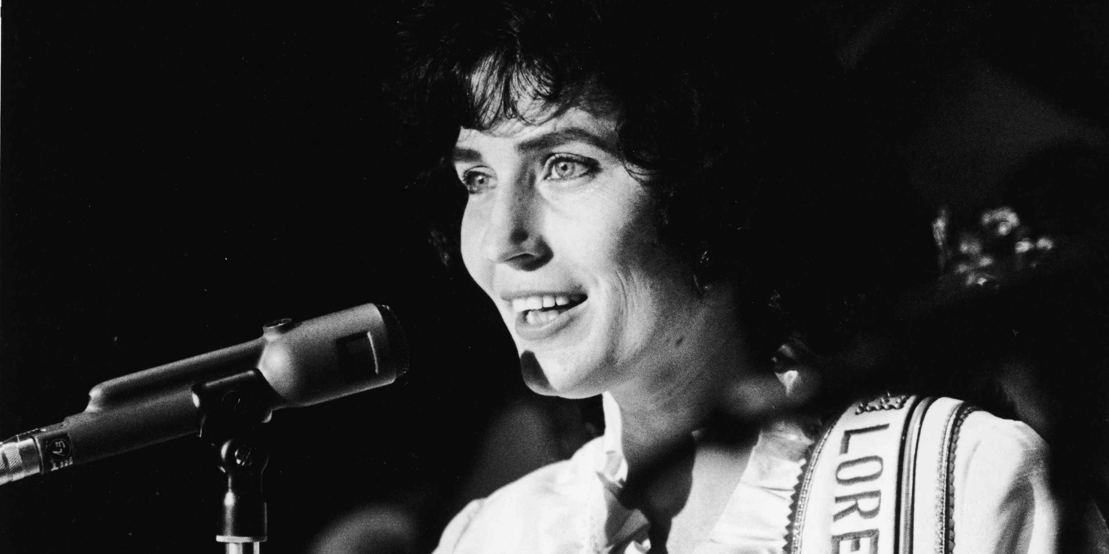 American country music singer and guitarist Loretta Lynn performs on stage at the Grand Ole Opry, 1960.