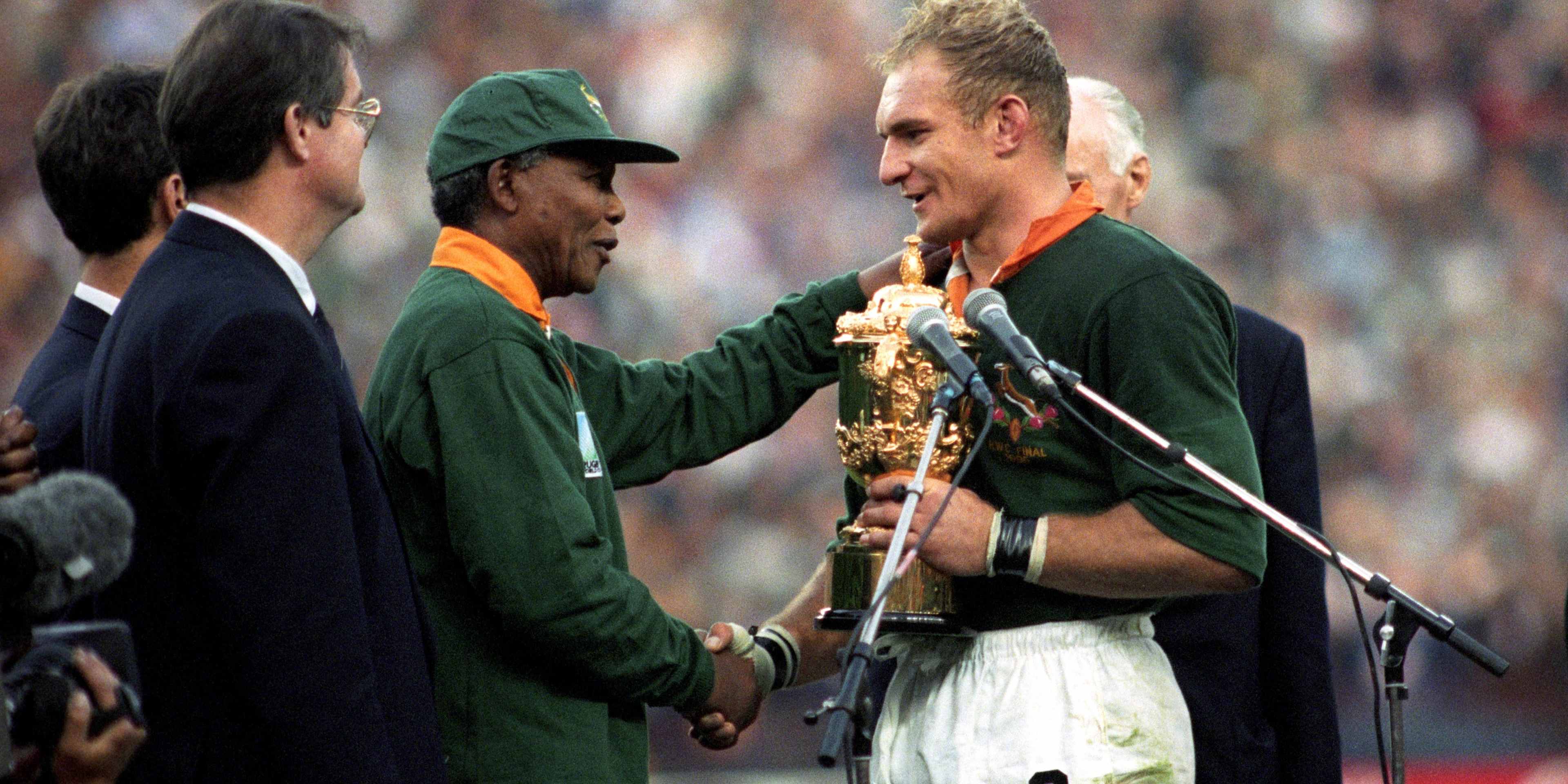 South Africa captain Francois Pienaar receives the William Webb Ellis Trophy from President Nelson Mandela after the home team defeated arch rival New Zealand in the 1995 Rugby Union World Cup in Johannesburg.