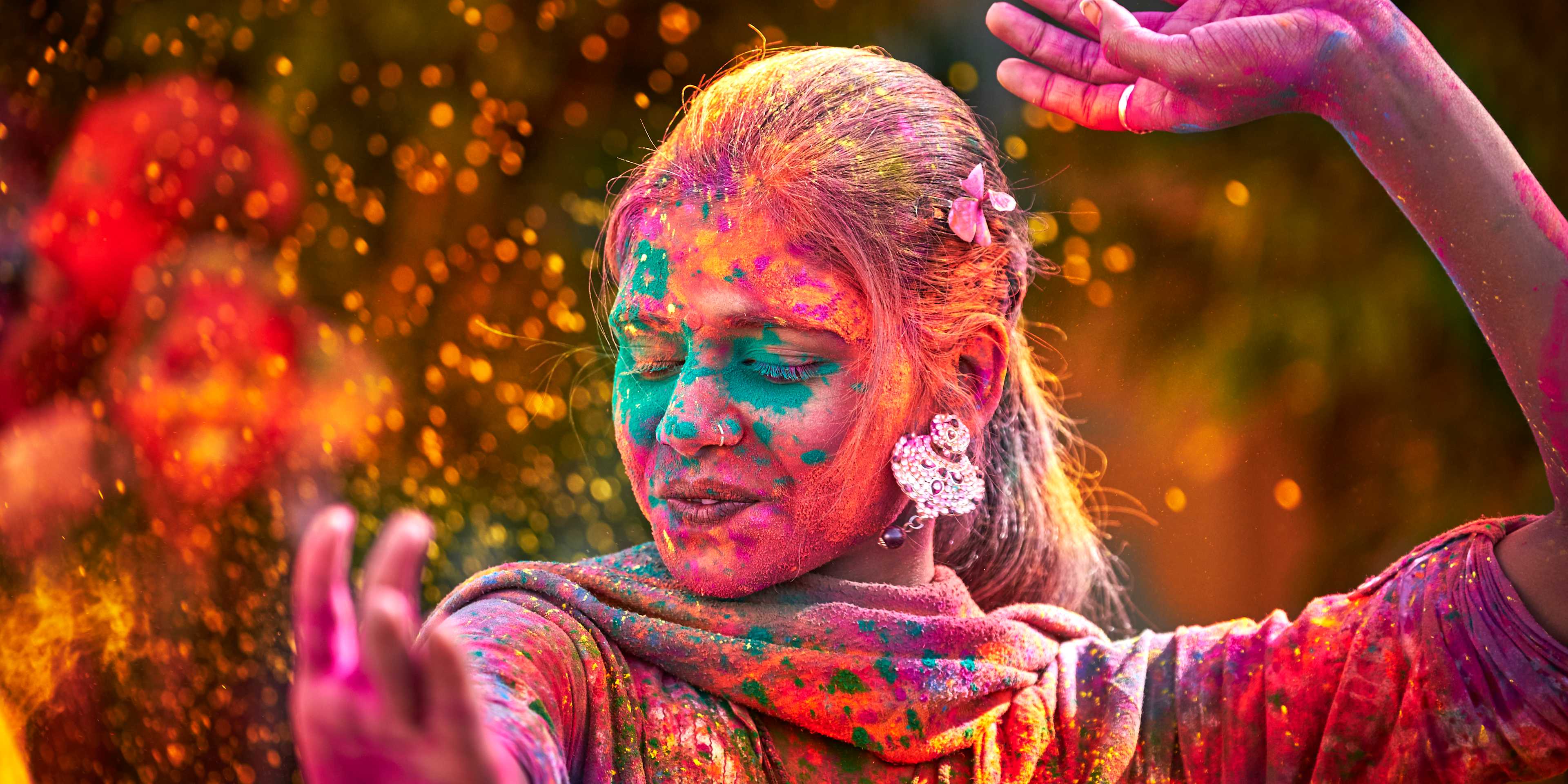 Portrait Of Indian Woman With Colored Face Dancing During Holi