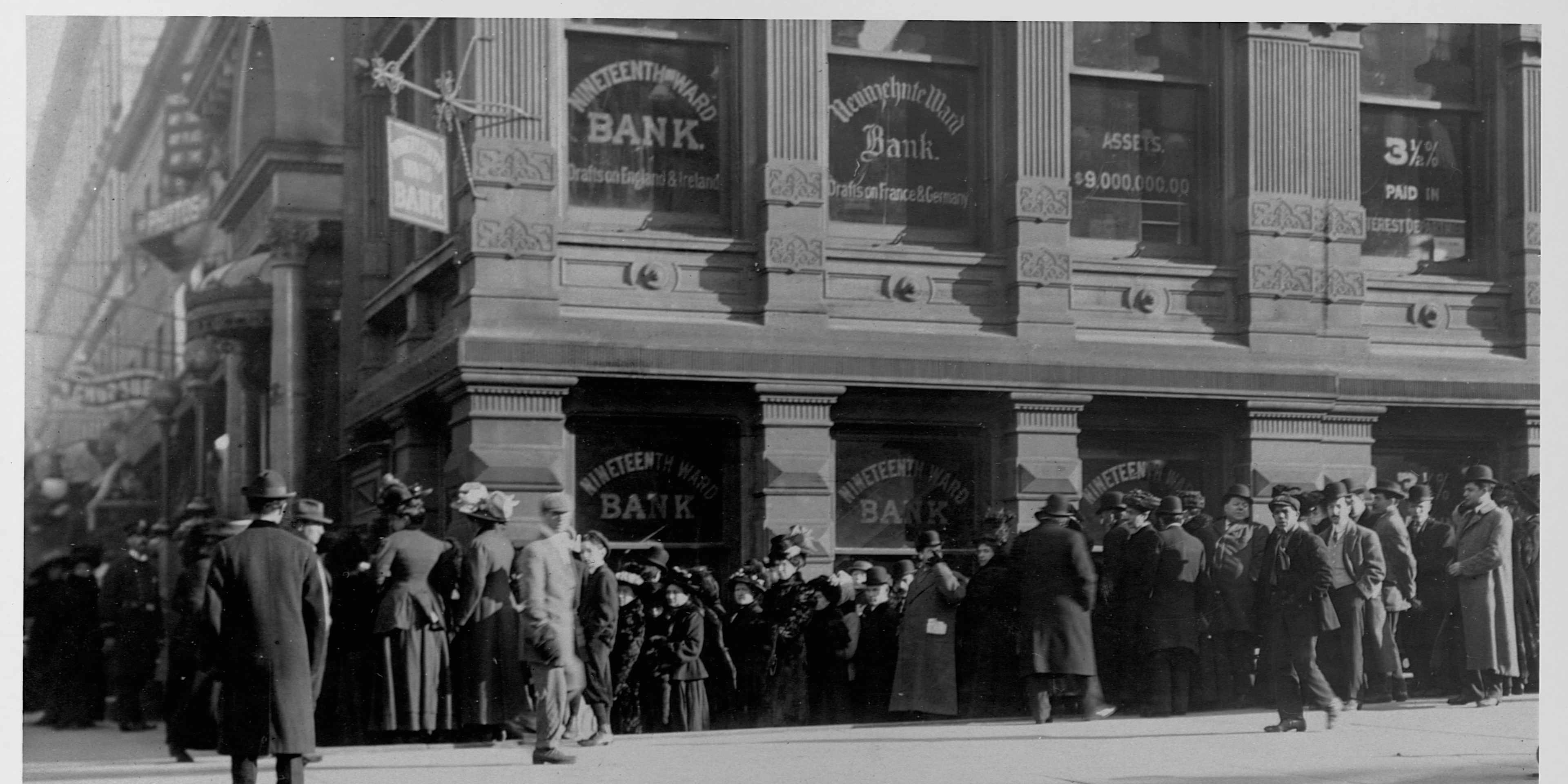 An anxious crowd gathers outside of New York's 19th Ward Bank, New York City.
