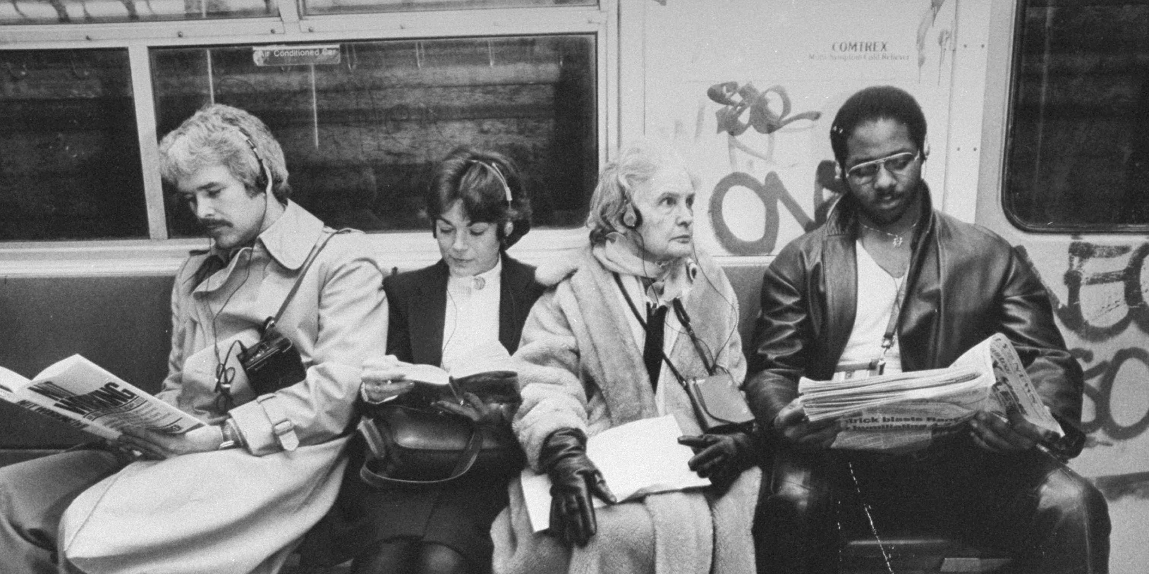 Four subway riders listening to their walkmans.