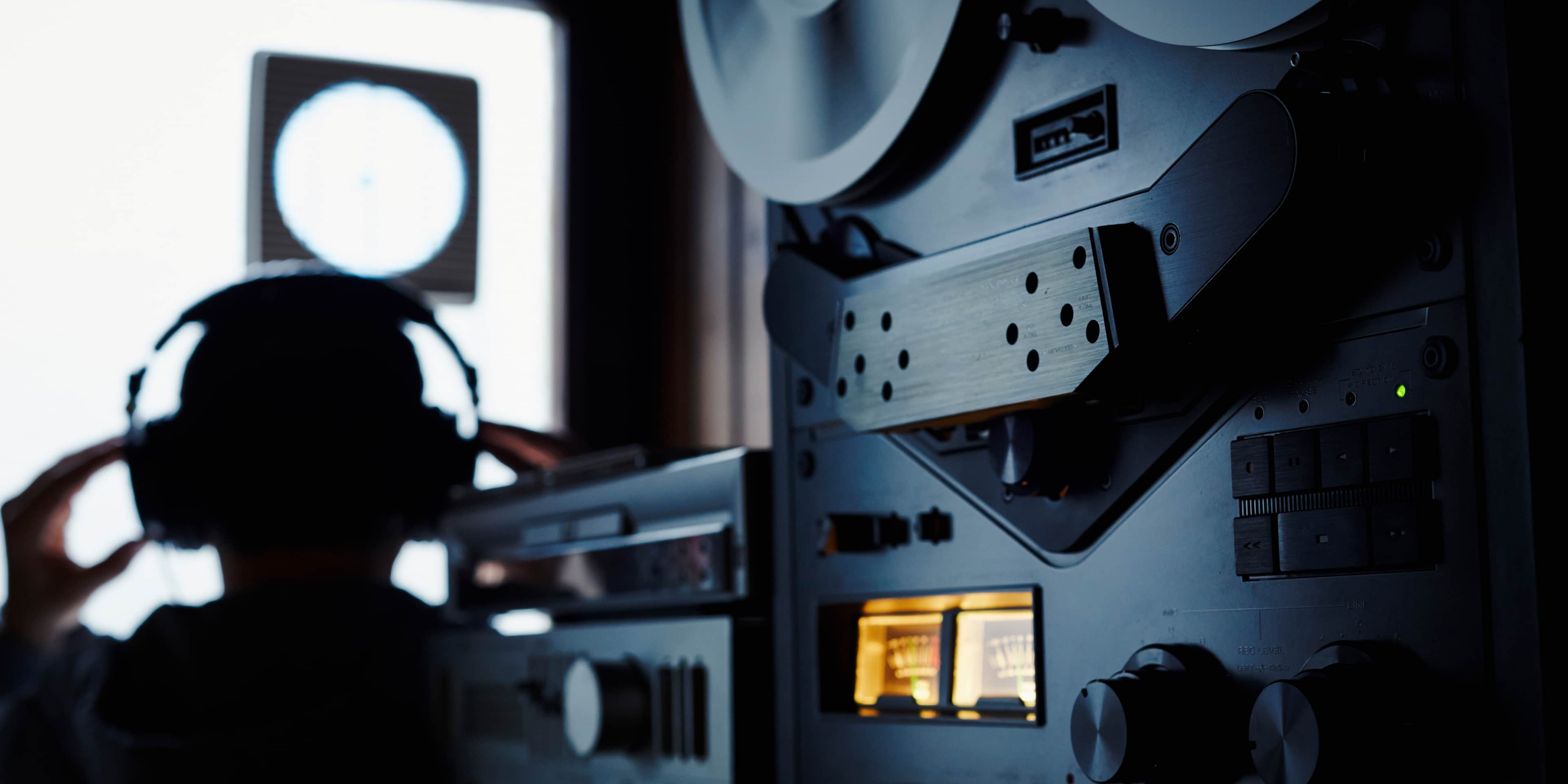 Germany, Bavaria, Man with head phone in recording studio