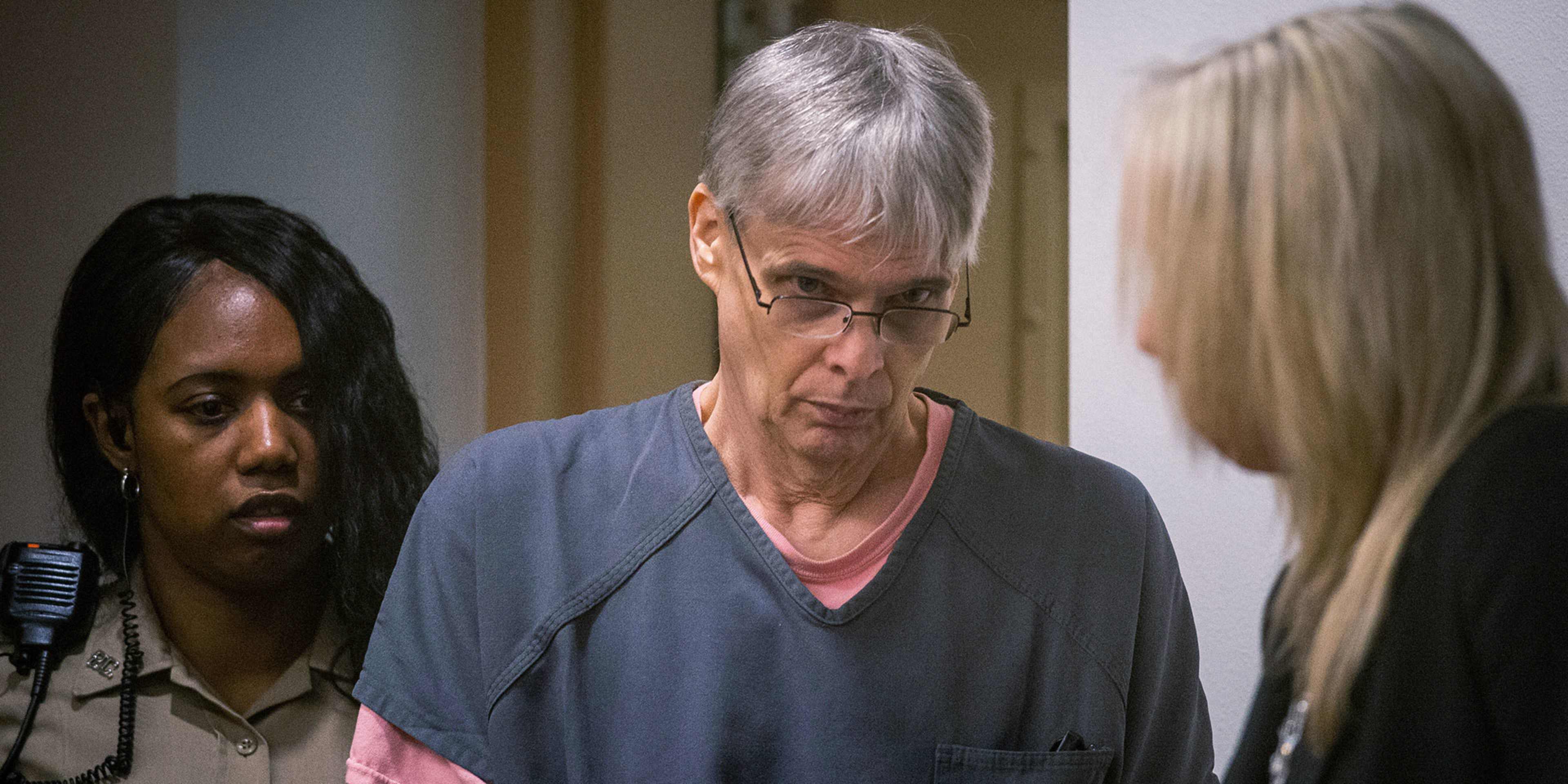 The image shows three individuals, an older woman with gray hair wearing glasses, a younger woman with long blonde hair, and a younger woman with dark braided hair, engaged in what appears to be a conversation or discussion.