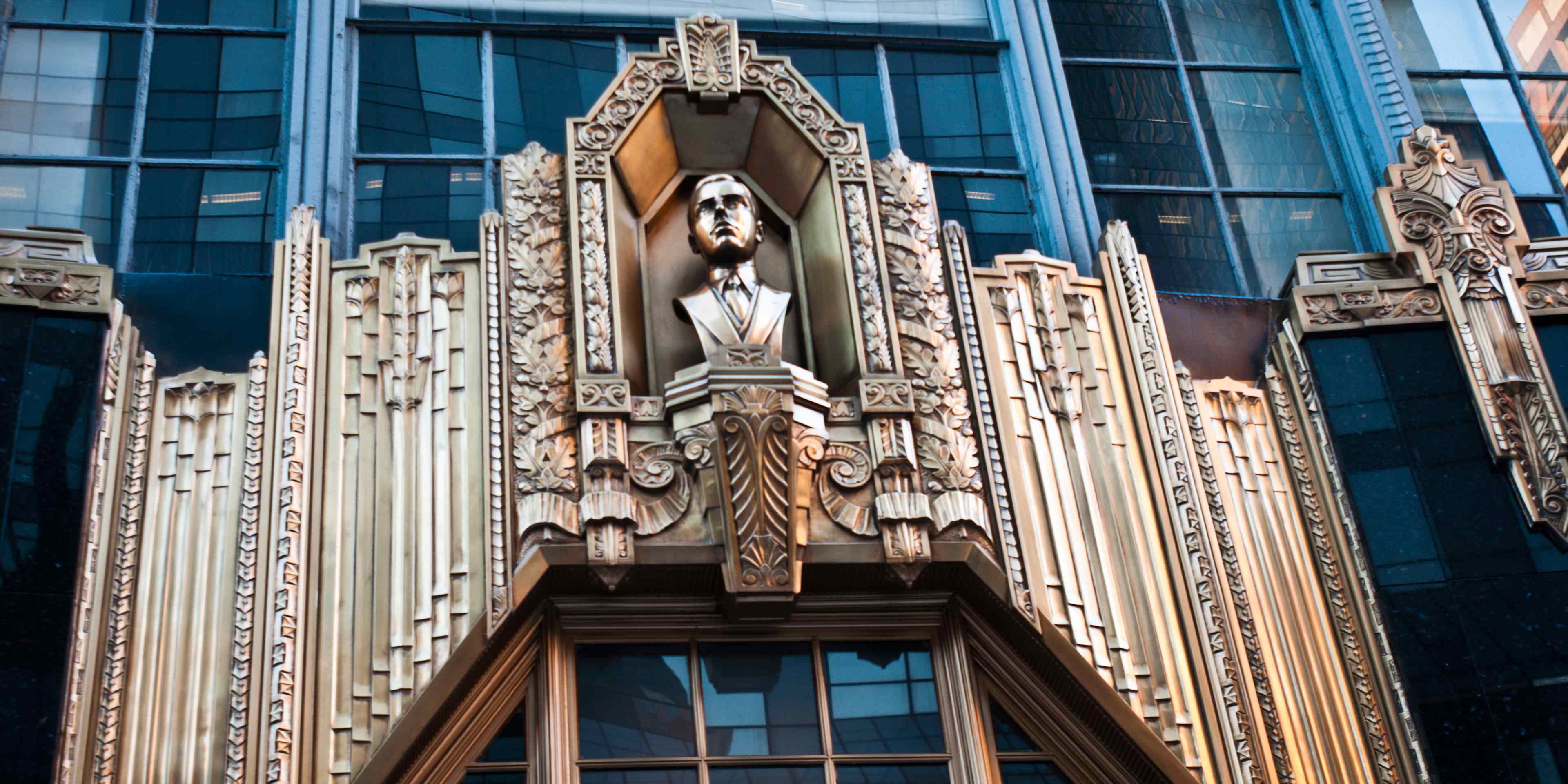Metal bass relief with statue of Alan E. Lefcourt above entrance to Brill Building, Times Square, Manhattan, New York City, USA
