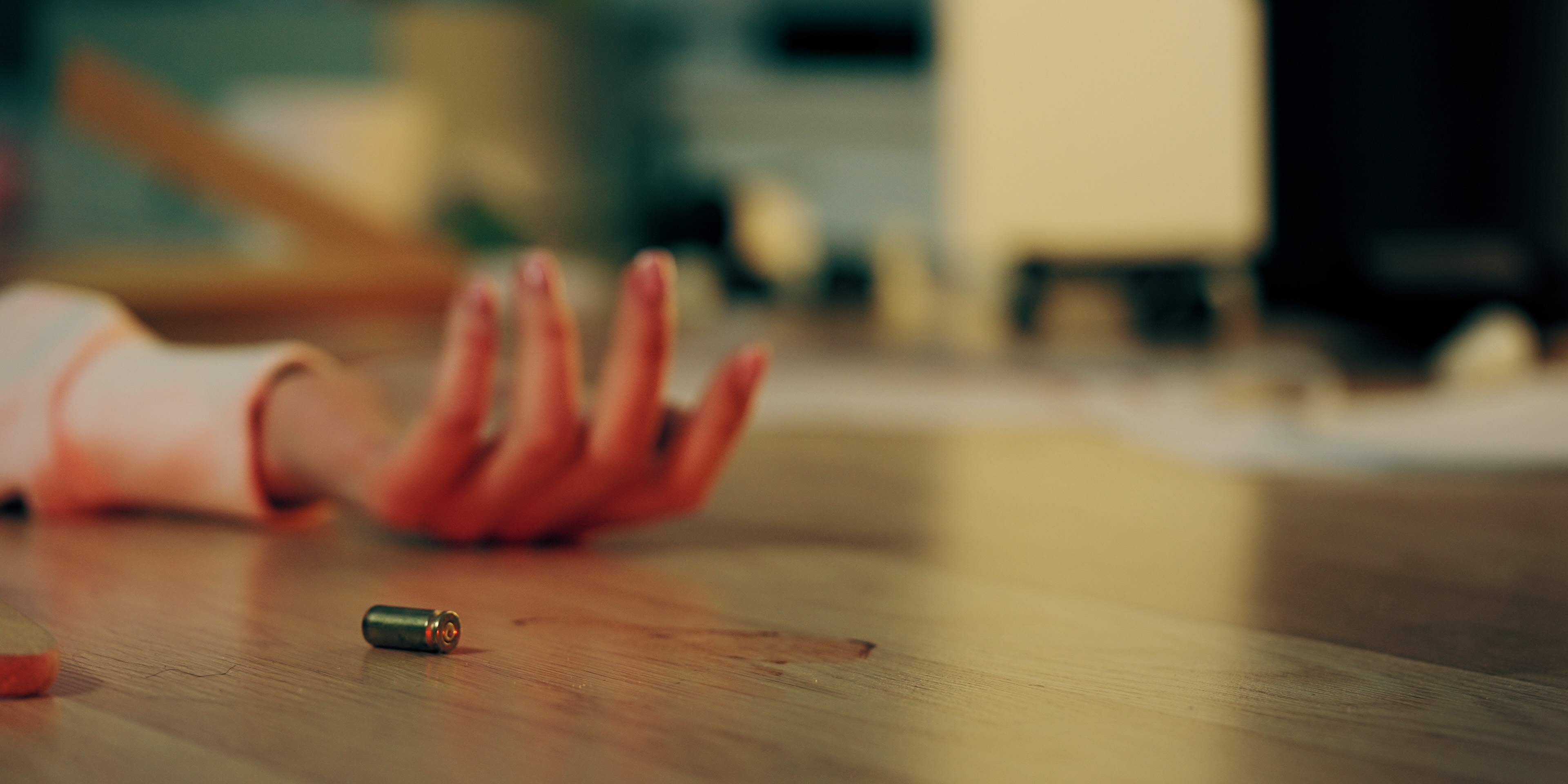 Woman lying on the floor after being shot.