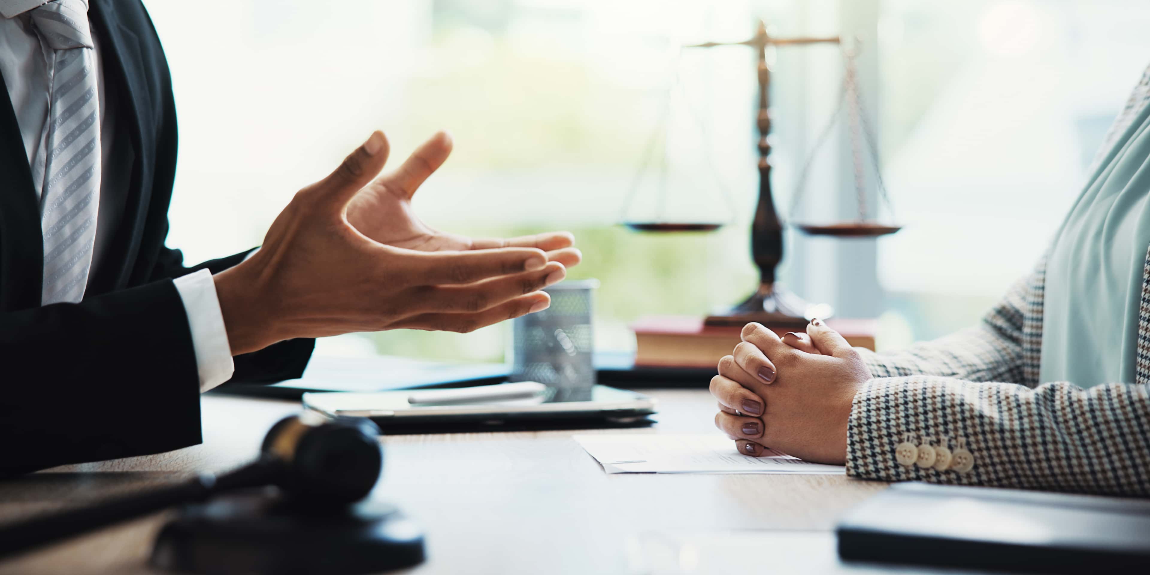 Meeting, lawyers and hands of business people in office for legal consultation, contract and discussion. Corporate, professional and workers with gavel for legislation, agreement and deal at law firm
