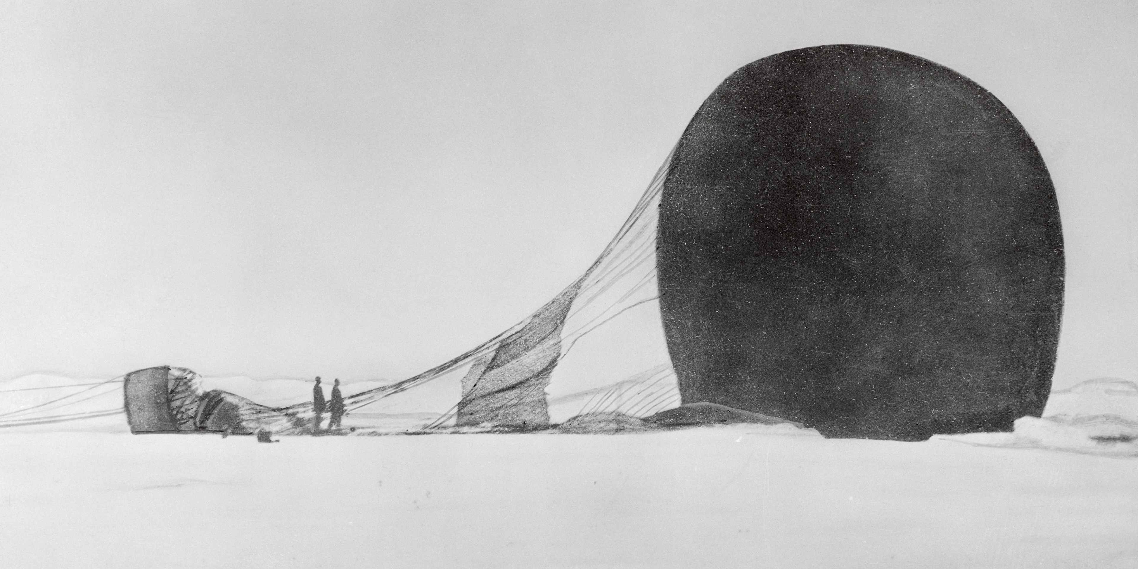 A dramatic snowy whiteout Arctic landscape with a hot air balloon lying on its side