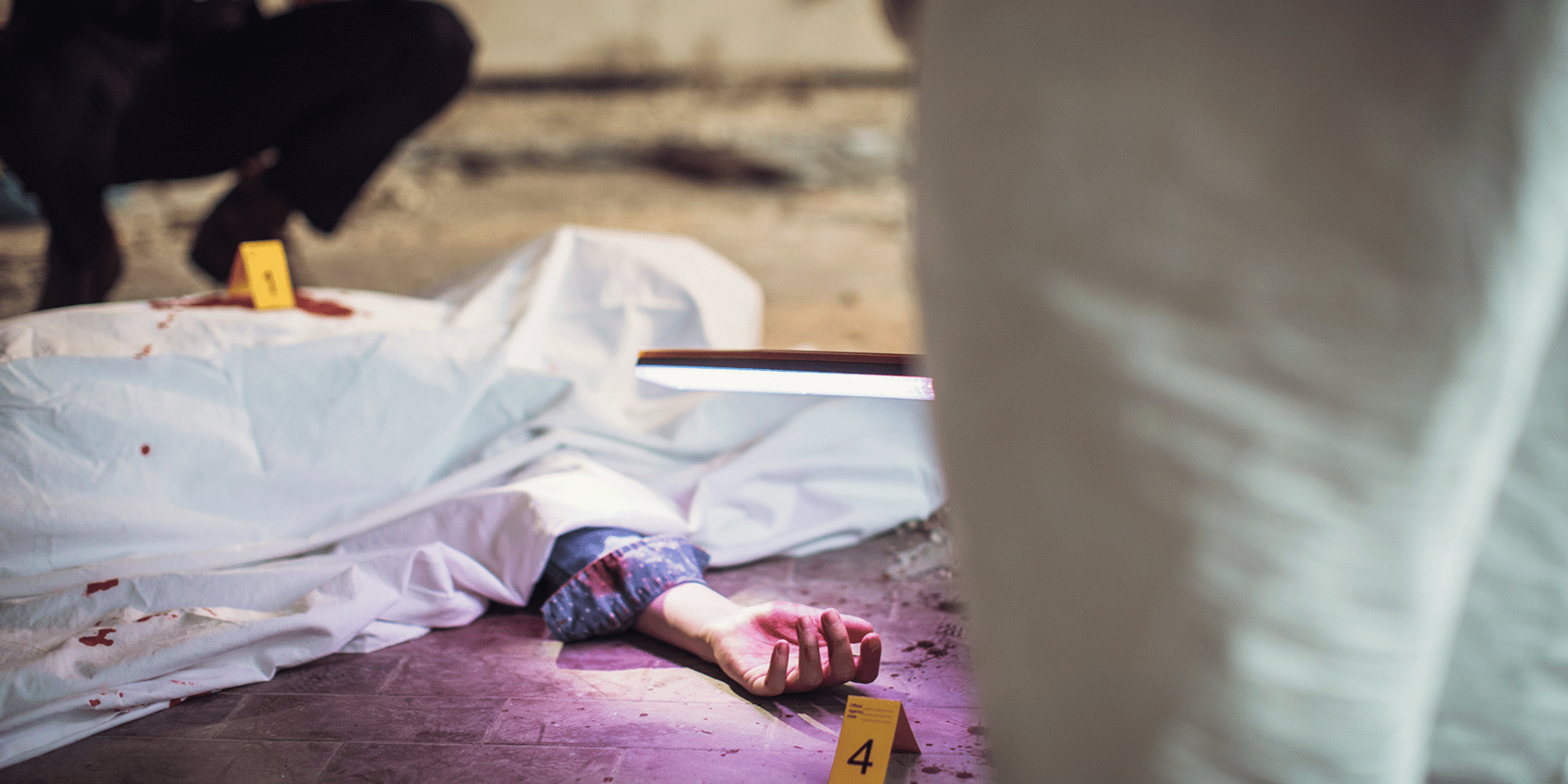 Conceptual photo of investigators collecting forensic evidence from a murder crime scene