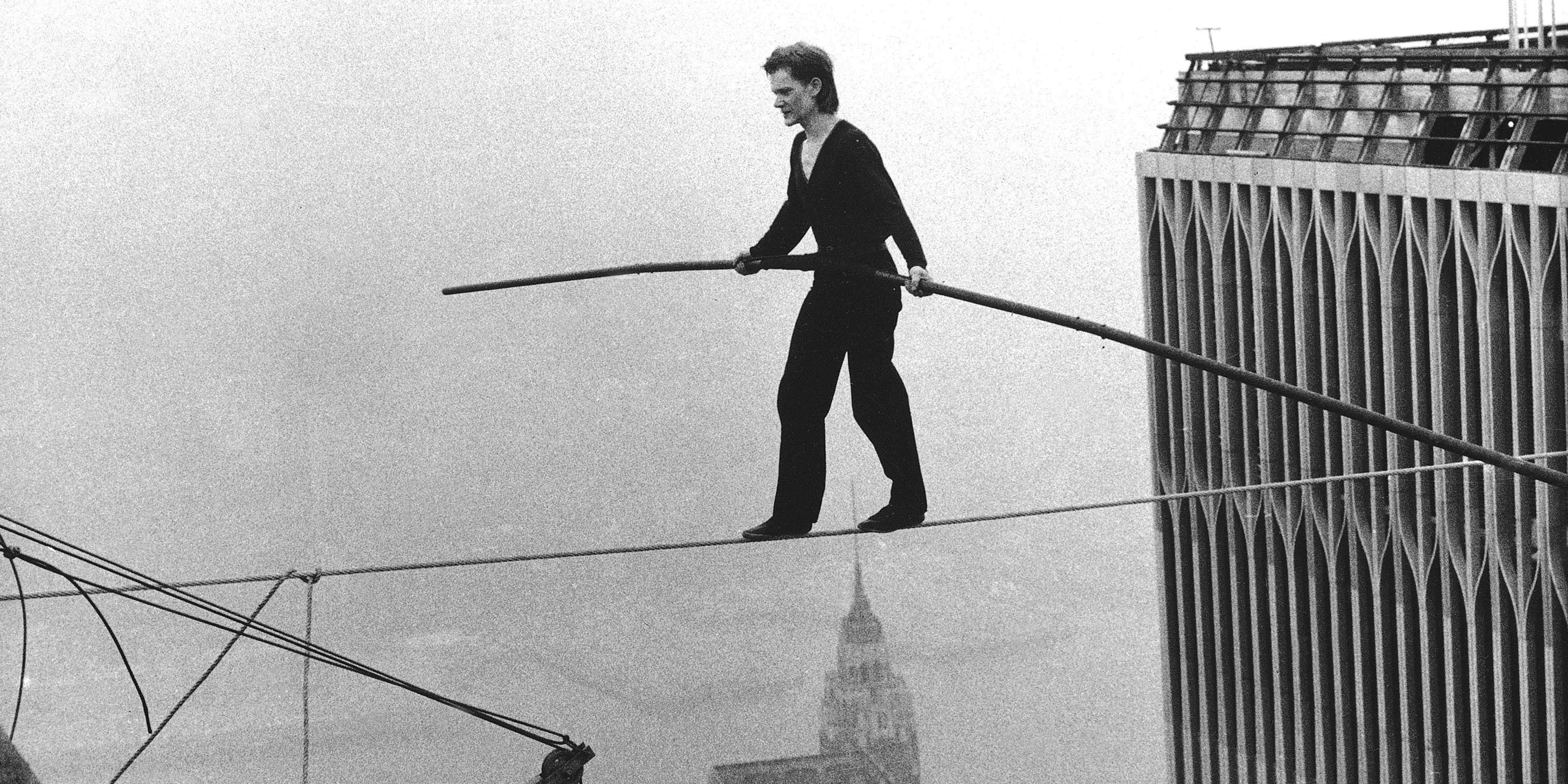 Philippe Petit crossing the Twin Towers on a tightrope.