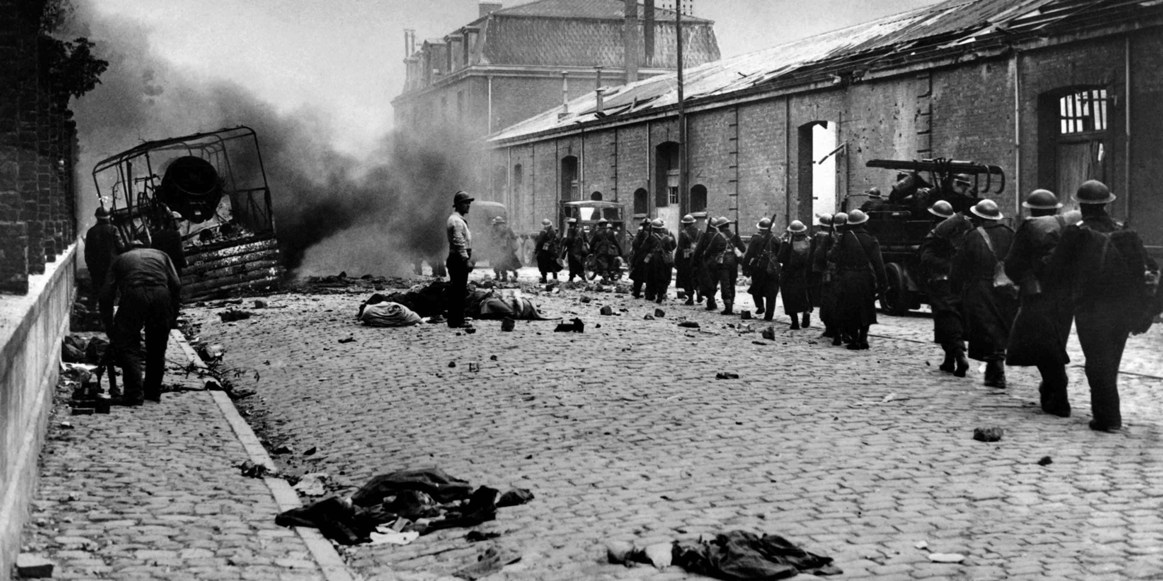 FRANCE-WAR-ARMY-BATTLE Undated picture of troops crossing the mids of debris of the rubble-strewn streets in Dunkerque, France, during the 2nd World war. (Photo by - / AFP) (Photo credit should read -/AFP via Getty Images)
