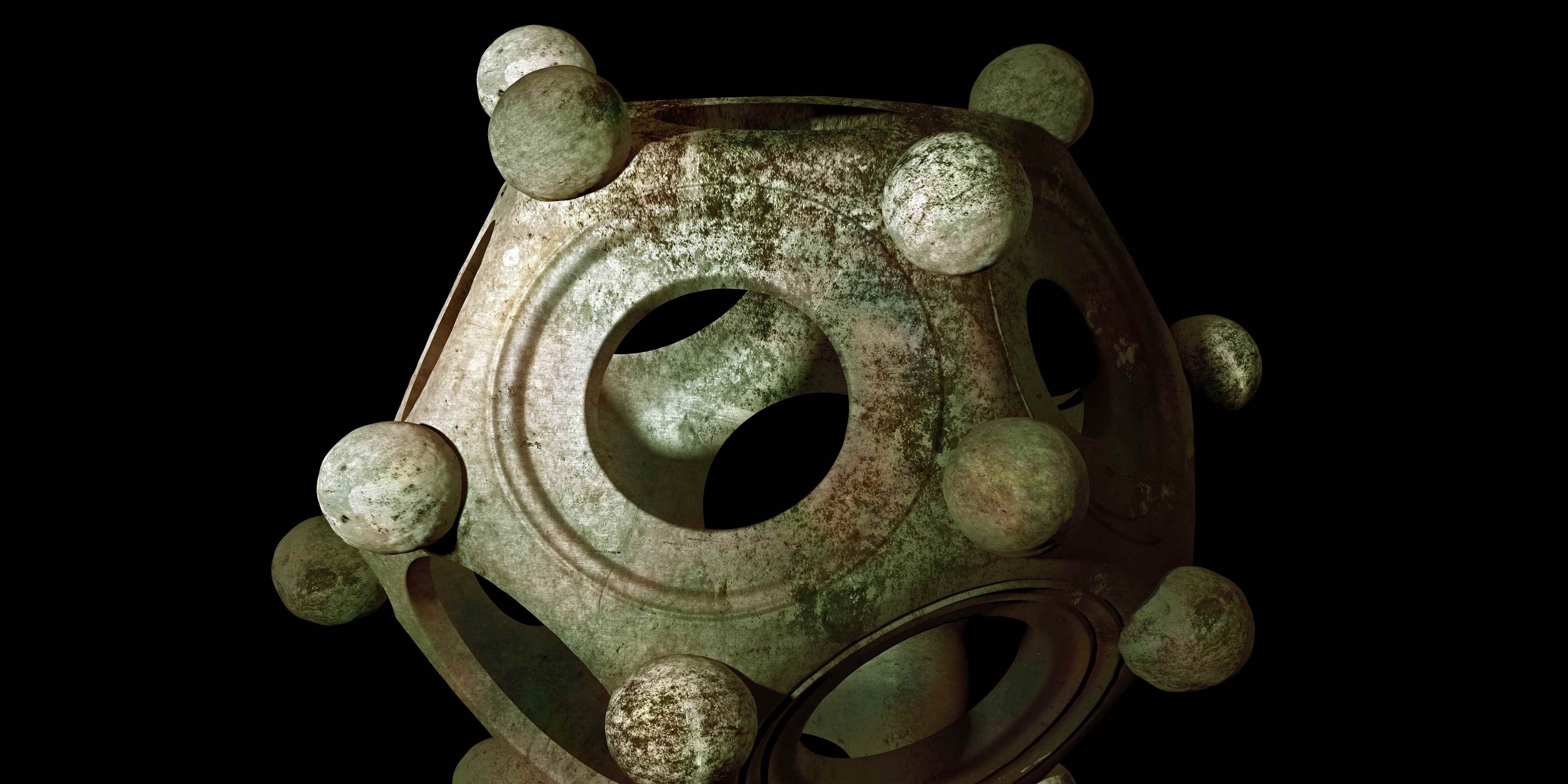Ancient bronze Roman dodecahedron on a black background