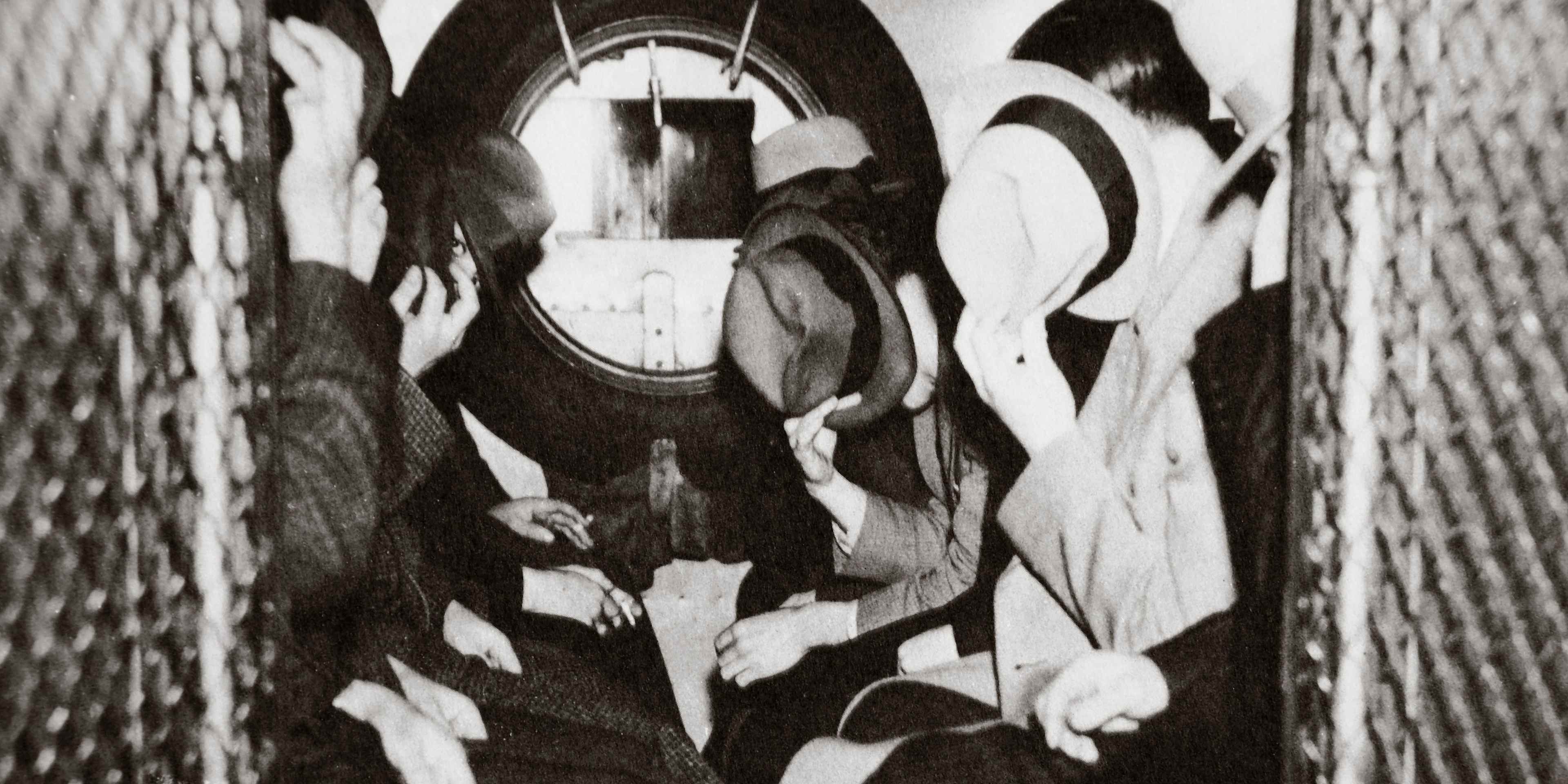 Gangsters in a patrol wagon, New York, USA, mid 1930s. Hiding their faces from the camera as they are on their way to the office of Special Prosecutor Thomas E Dewey. Dewey (1902-1971) was appointed Special Prosecutor to lead the fight against crime and corruption in New York. He later went on to serve as Governor of the state of New York (1943-1954) and was the unsuccessful Republican candidate for the US Presidency in 1944 and 1948. (Photo by Historica Graphica Collection/Heritage Images/Getty Images)