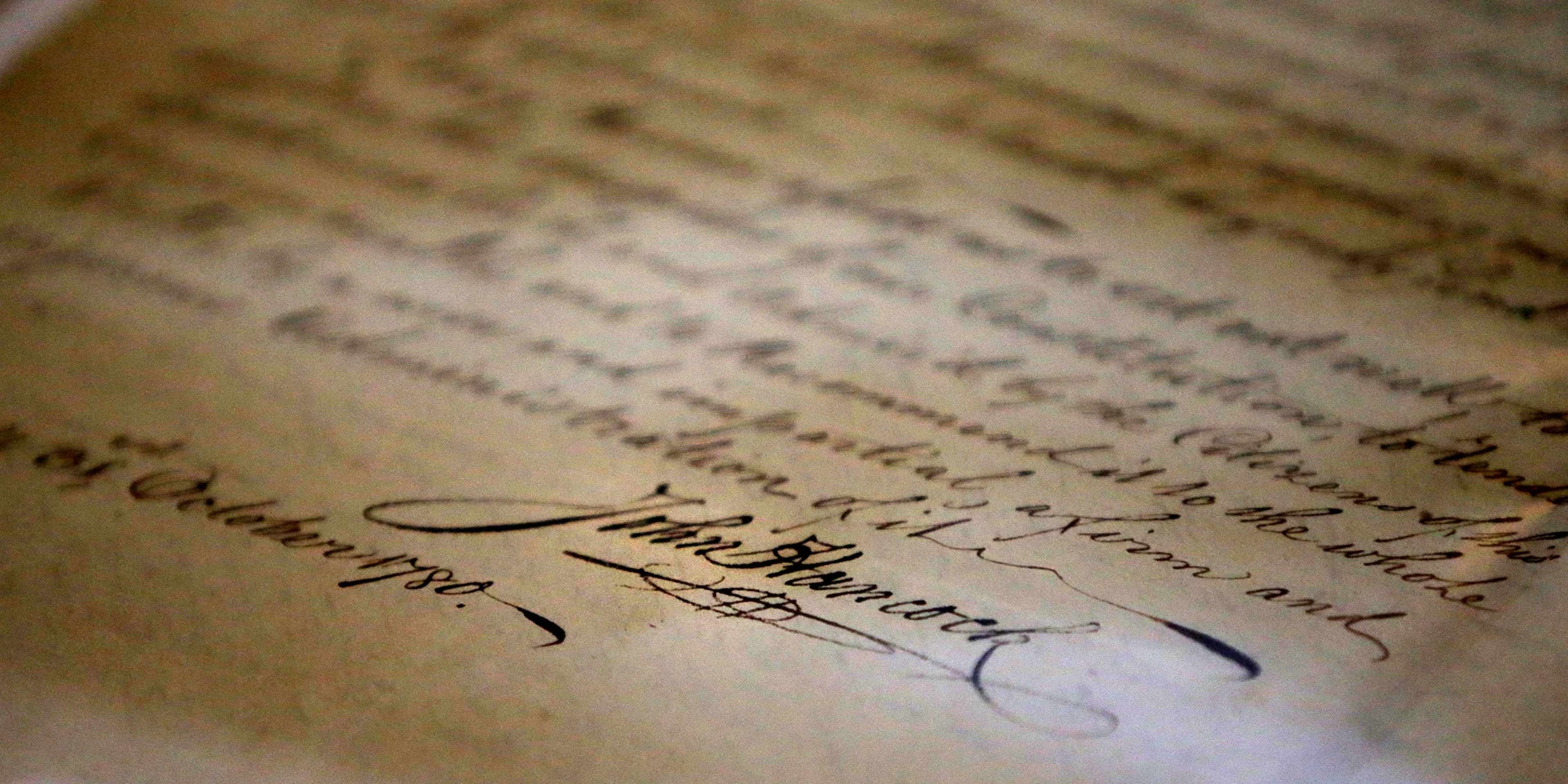 BOSTON, MA - JANUARY 29: John Hancock's signature is seen at the bottom of his inaugural address as Governor, a document stored at the Massachusetts State Archives in Boston on Jan. 29, 2019. Massachusetts officials on Tuesday unveiled a new vault to store the commonwealth's myriad historical treasures and documents accumulated over nearly four centuries. The expanded 25,000 square-foot space in Dorchester allow the archives to grow after the Columbia Point building reached a "critical point" of limited space, said Michael Comeau, executive director of the archives. The space also features modern environmental and security controls. (Photo by Lane Turner/The Boston Globe via Getty Images)
