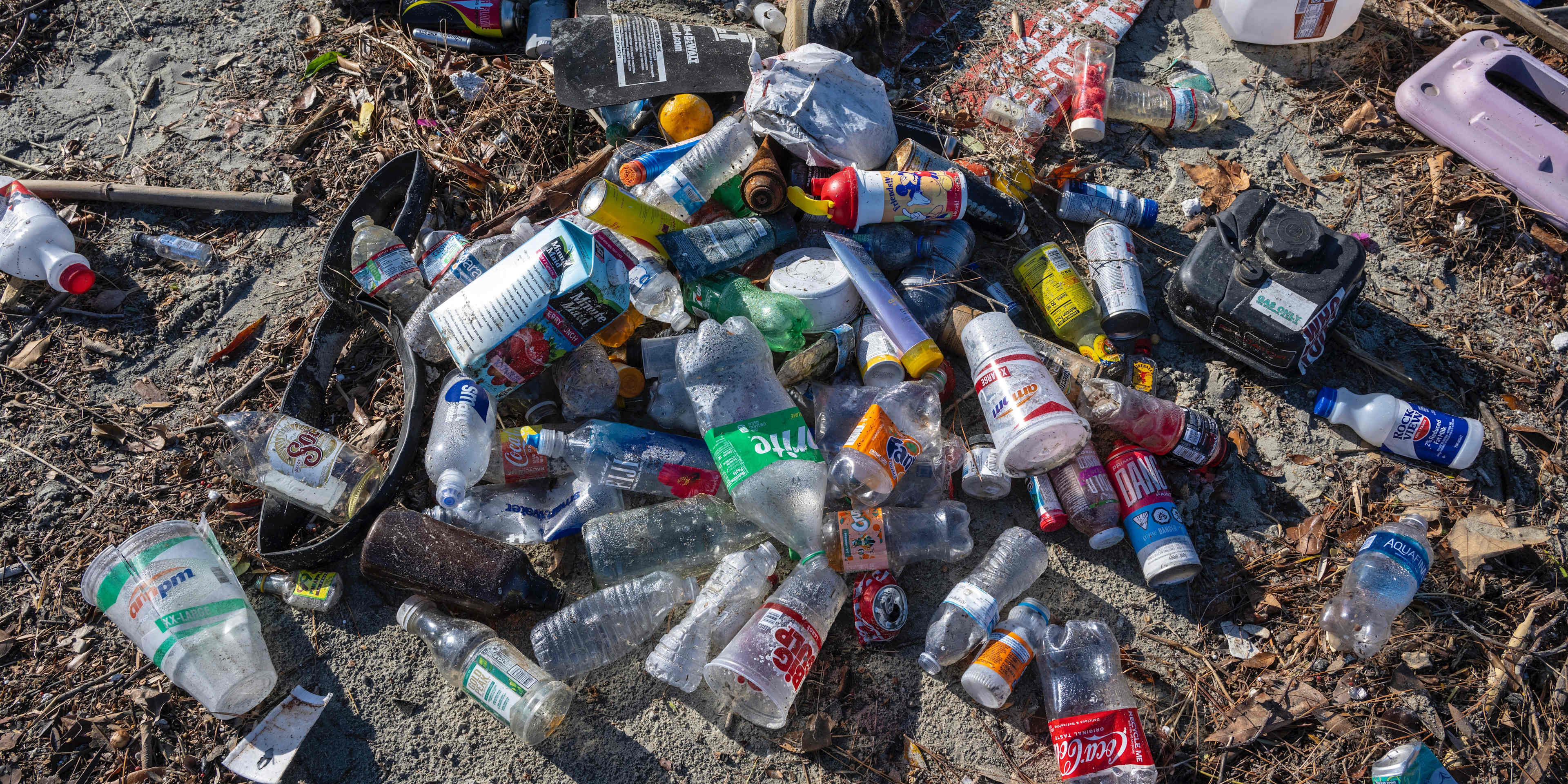 Plastic bottles and other trash piled up along the bank of the San Gabriel River just a few hundred yards from the Pacific Ocean in Seal Beach, California.