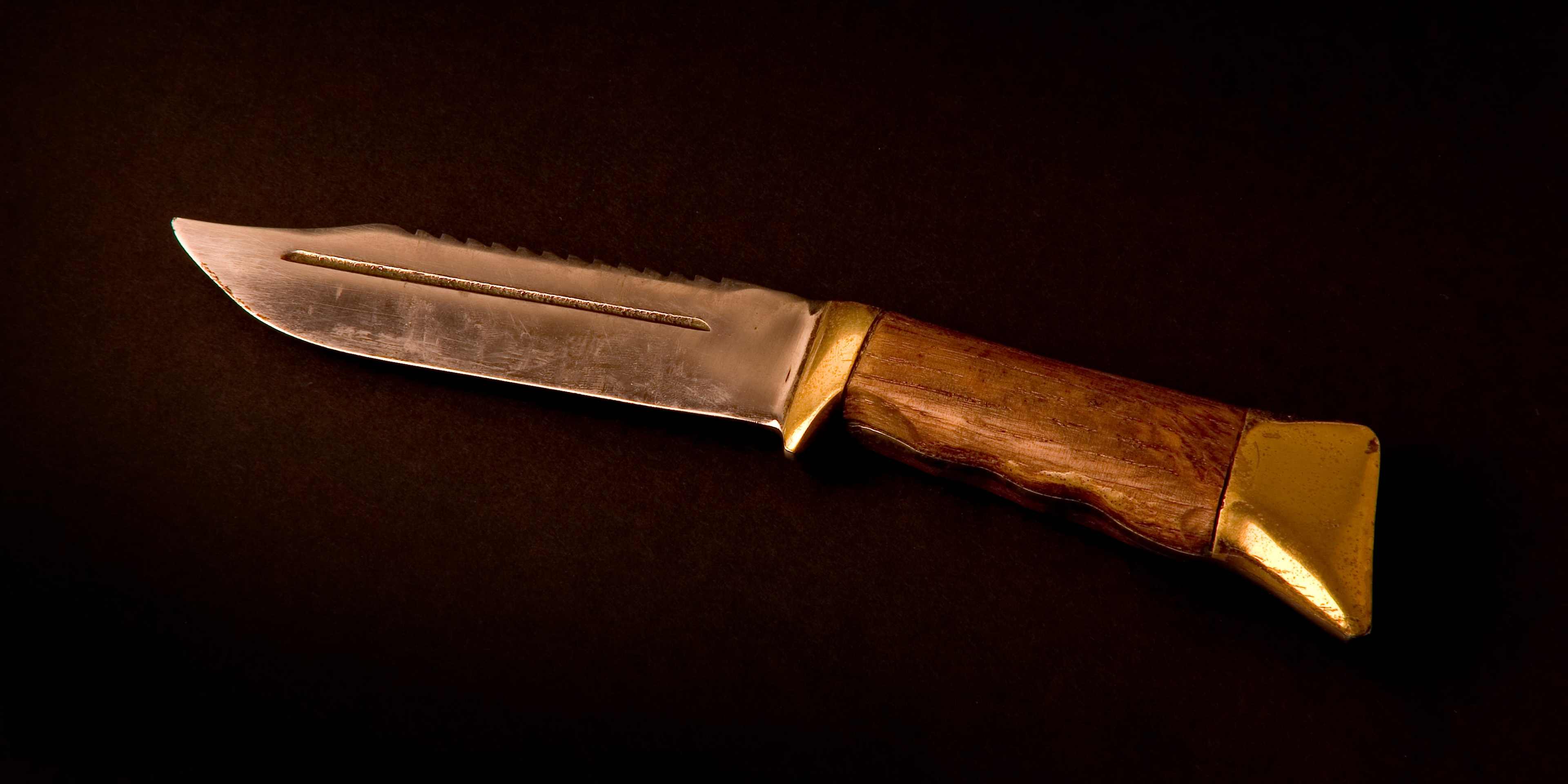 Big hunting knife with dramatic lighting.