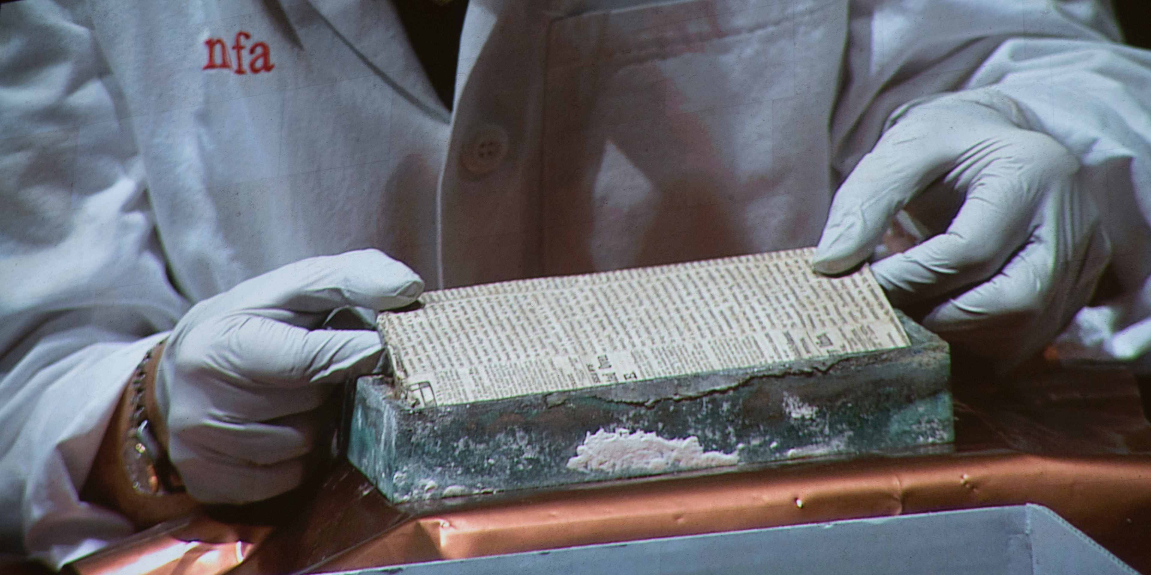 Pamela Hatchfield, of the Museum of Fine Arts, Boston removing a newspaper after opening a time capsule that was the cornerstone of the Massachusetts State House, buried in 1795, opened on January 6, 2015 at the Museum of Fine Arts in Boston, MA.