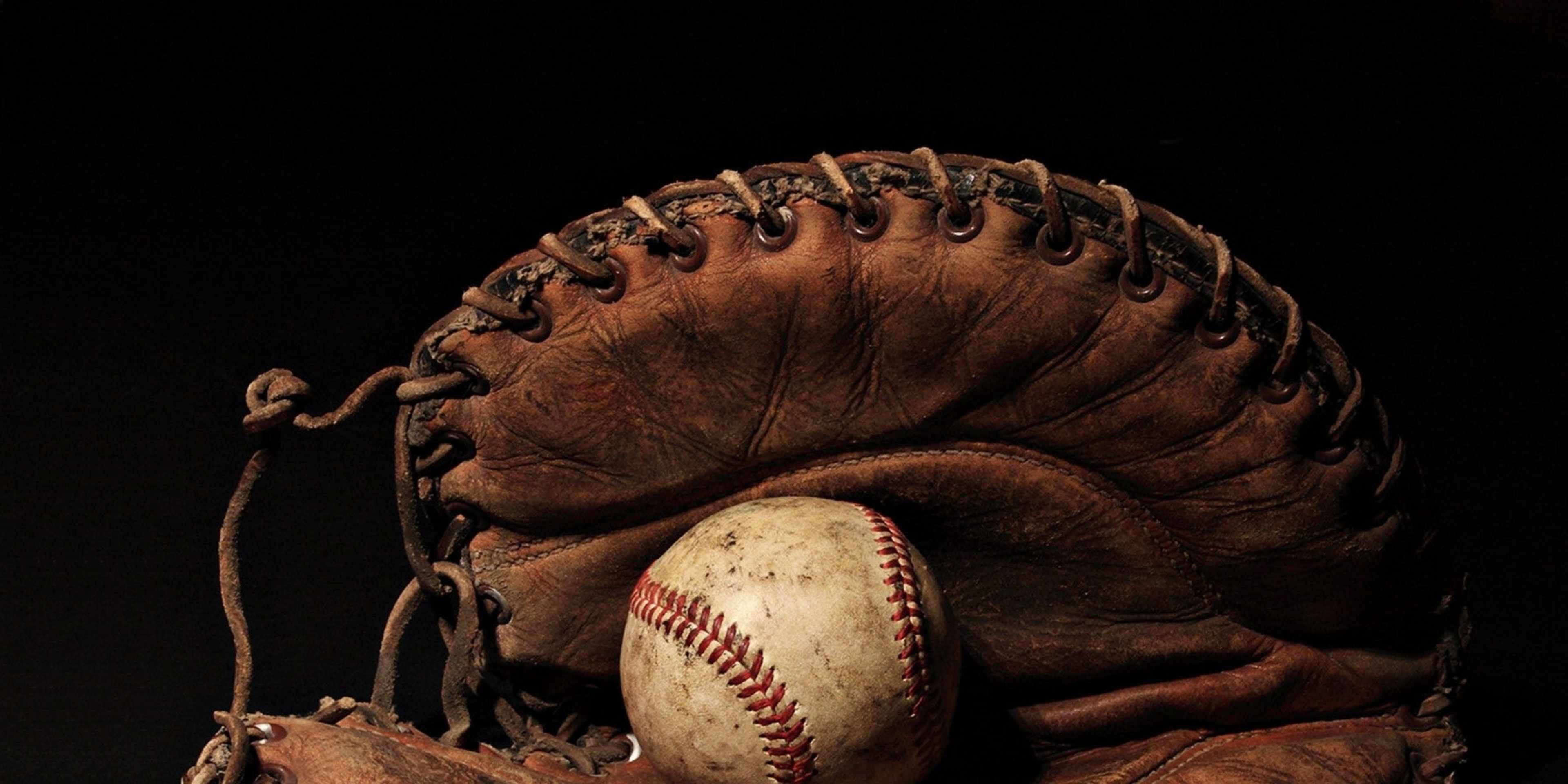 A baseball in a baseball mitt.