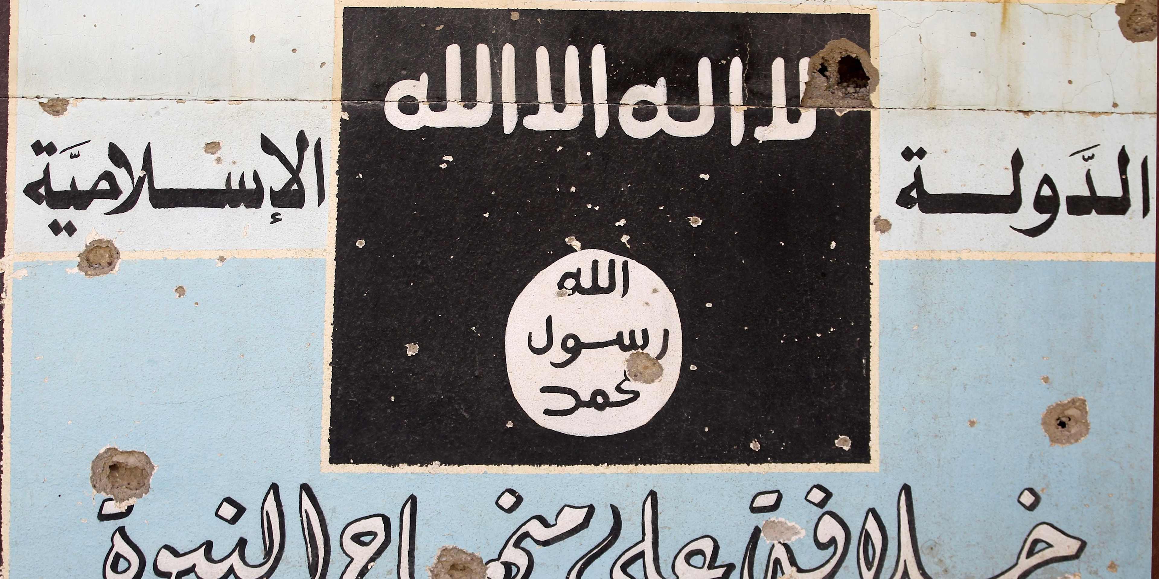 A picture shows a mural depicting the emblem of the Islamic State (IS) group