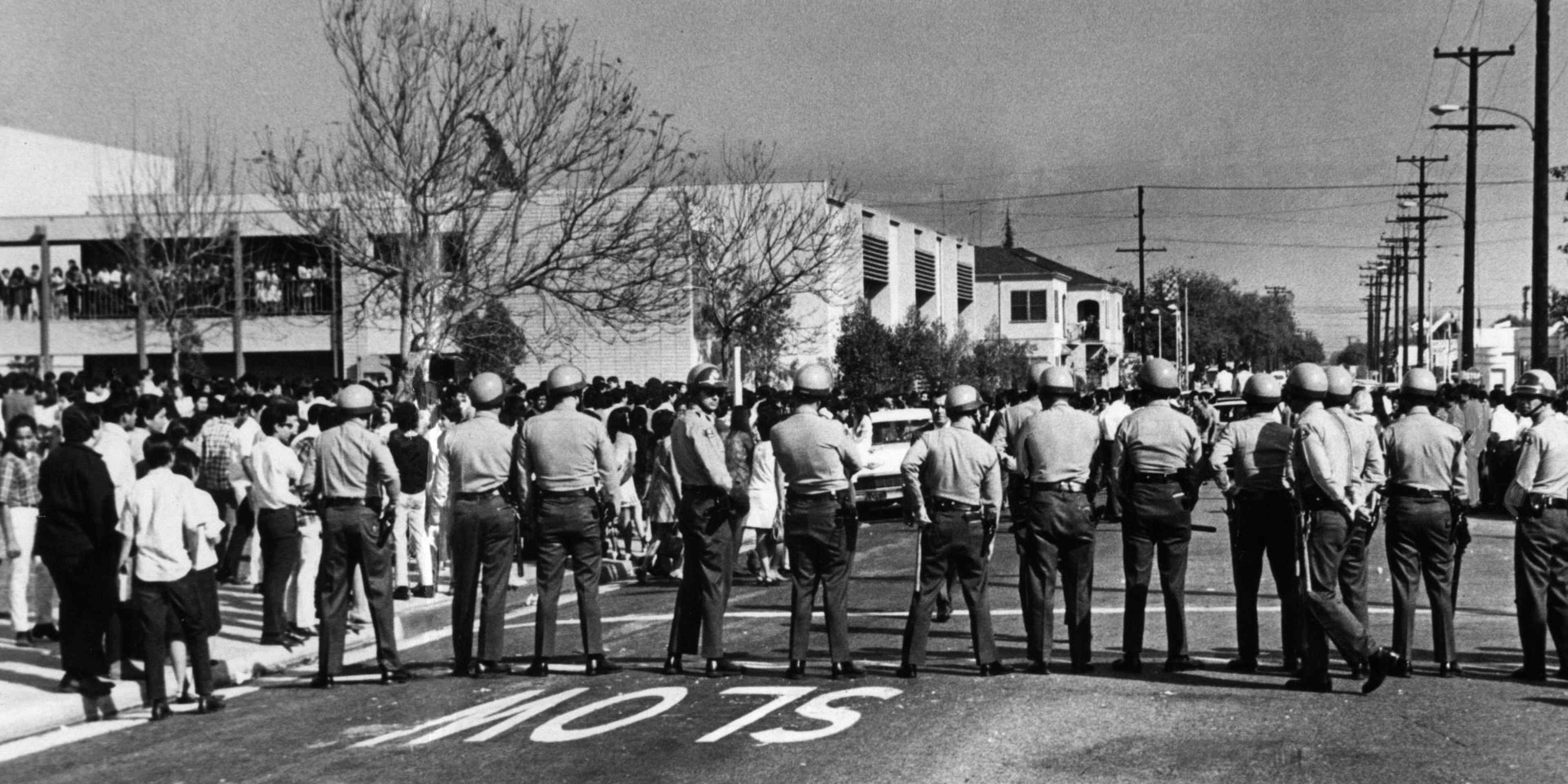 Sheriff's deputies form a line across street at Garfield High School during a Chicano student demonstration on March 5, 1968. Similar confrontations occurred at other schools.