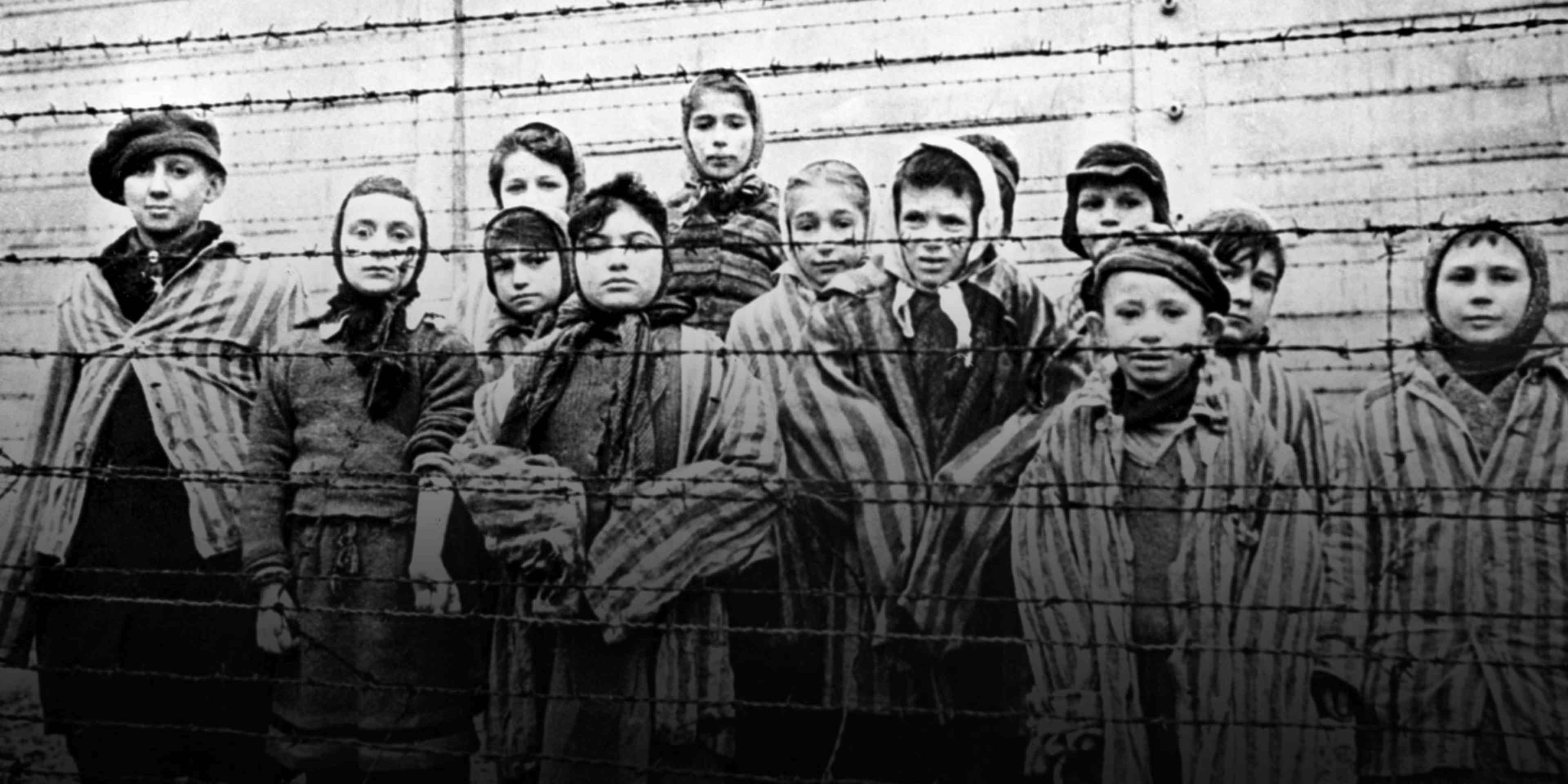 A group of child survivors behind a barbed wire fence at the Nazi concentration camp at Auschwitz-Birkenau in southern Poland, on the day of the camp’s liberation by the Red Army, 27th January 1945.