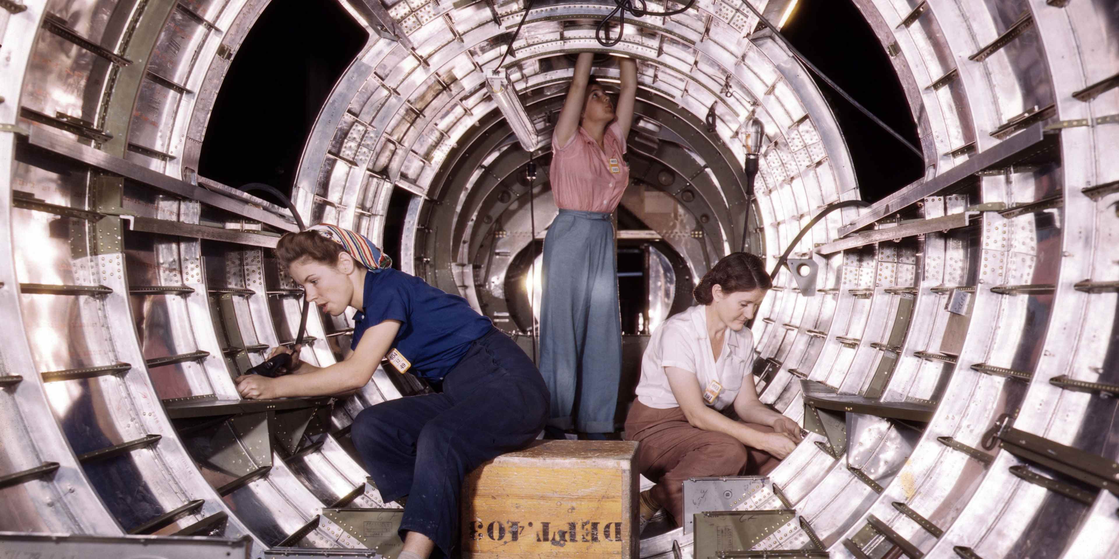 Women workers install fixtures and assemblies to a tail fuselage section of a B-17 bomber at the Douglas Aircraft Company plant in Long Beach, California.