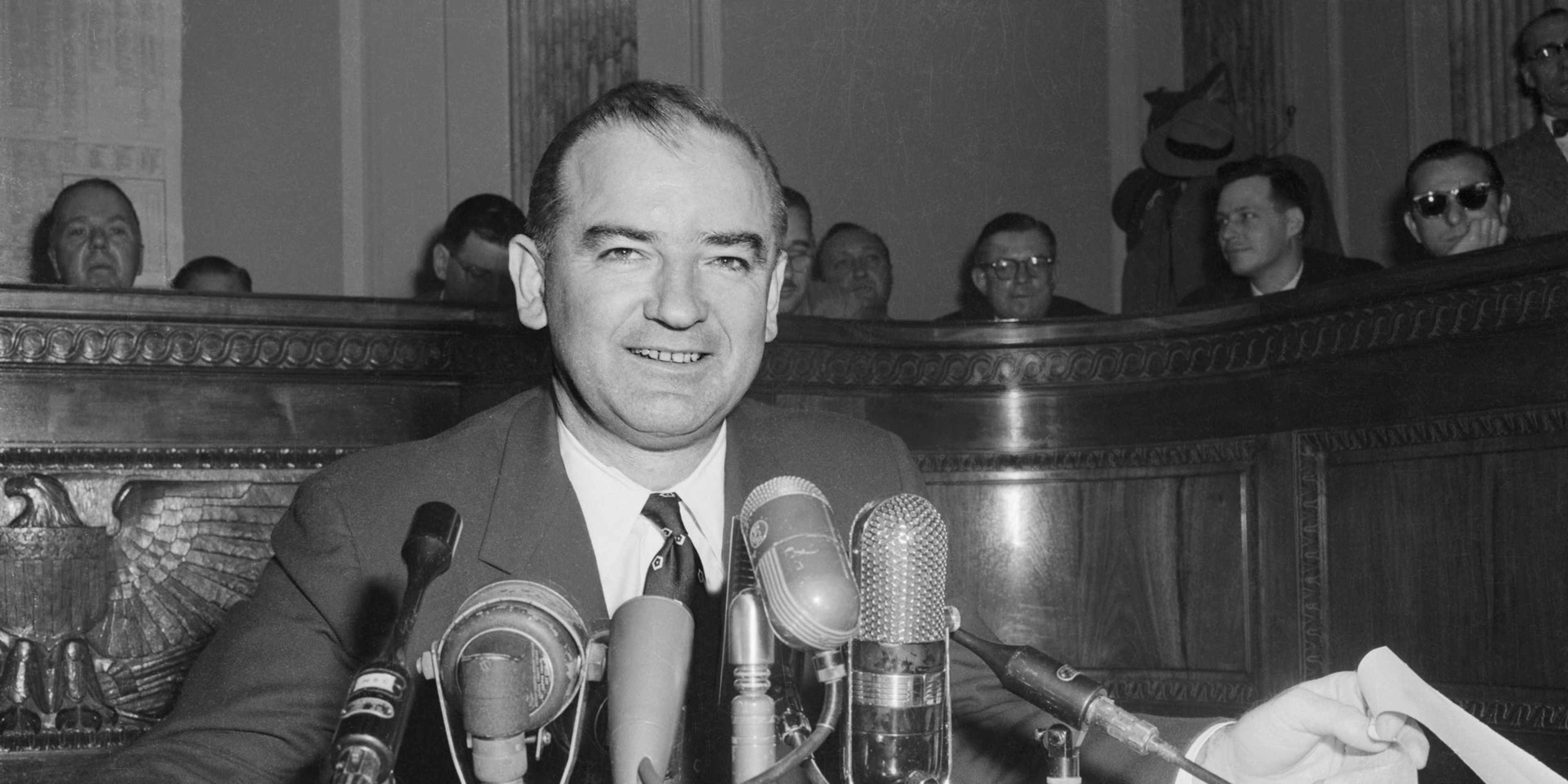 Senator McCarthy Attending US Army Hearings (Original Caption) Senator Joseph R. McCarthy chairman of the Senate Investigations Subcommittee, is shown as he took center stage again to comment on the latest developments in his dispute with the White House and Army Secretary Robert T. Stevens.