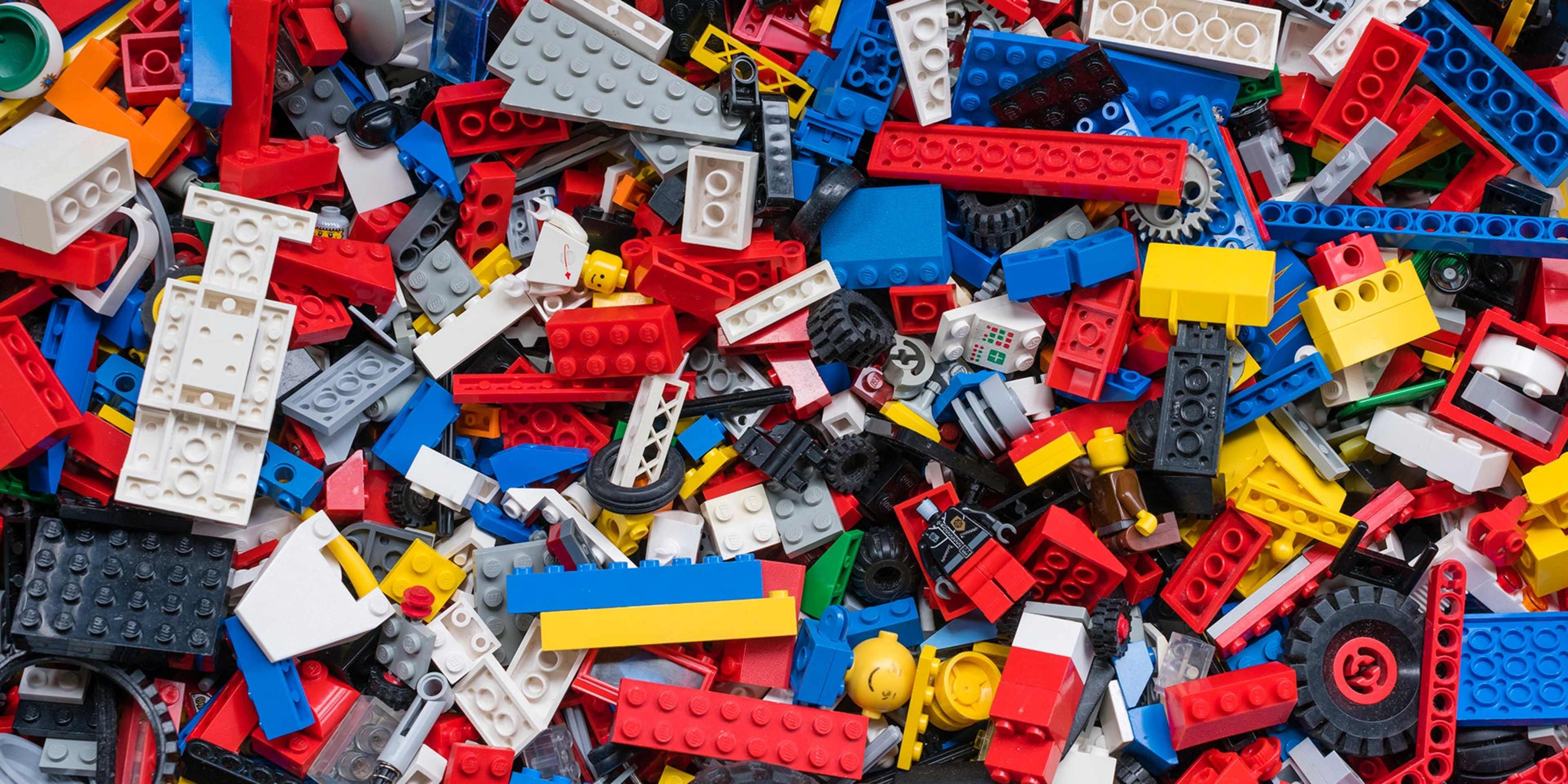 Cluttered pile of many colorful Lego bricks.