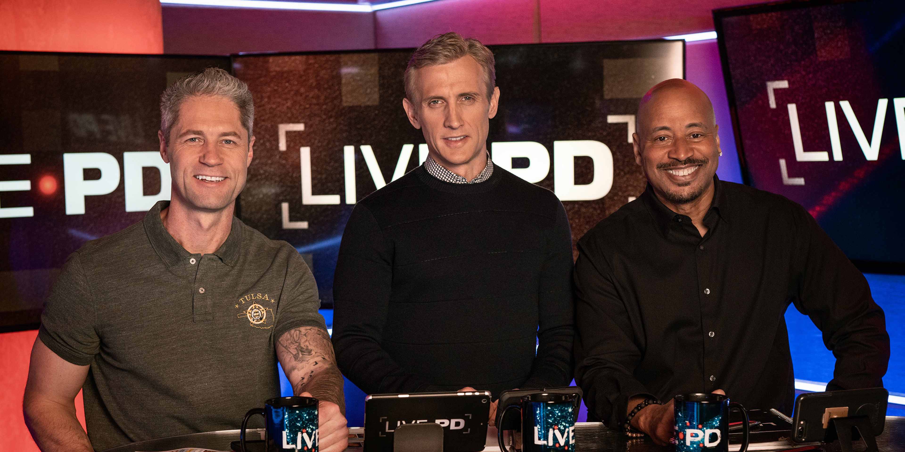 Three men standing in front of a backdrop with the text "LIVE PD" displayed prominently.