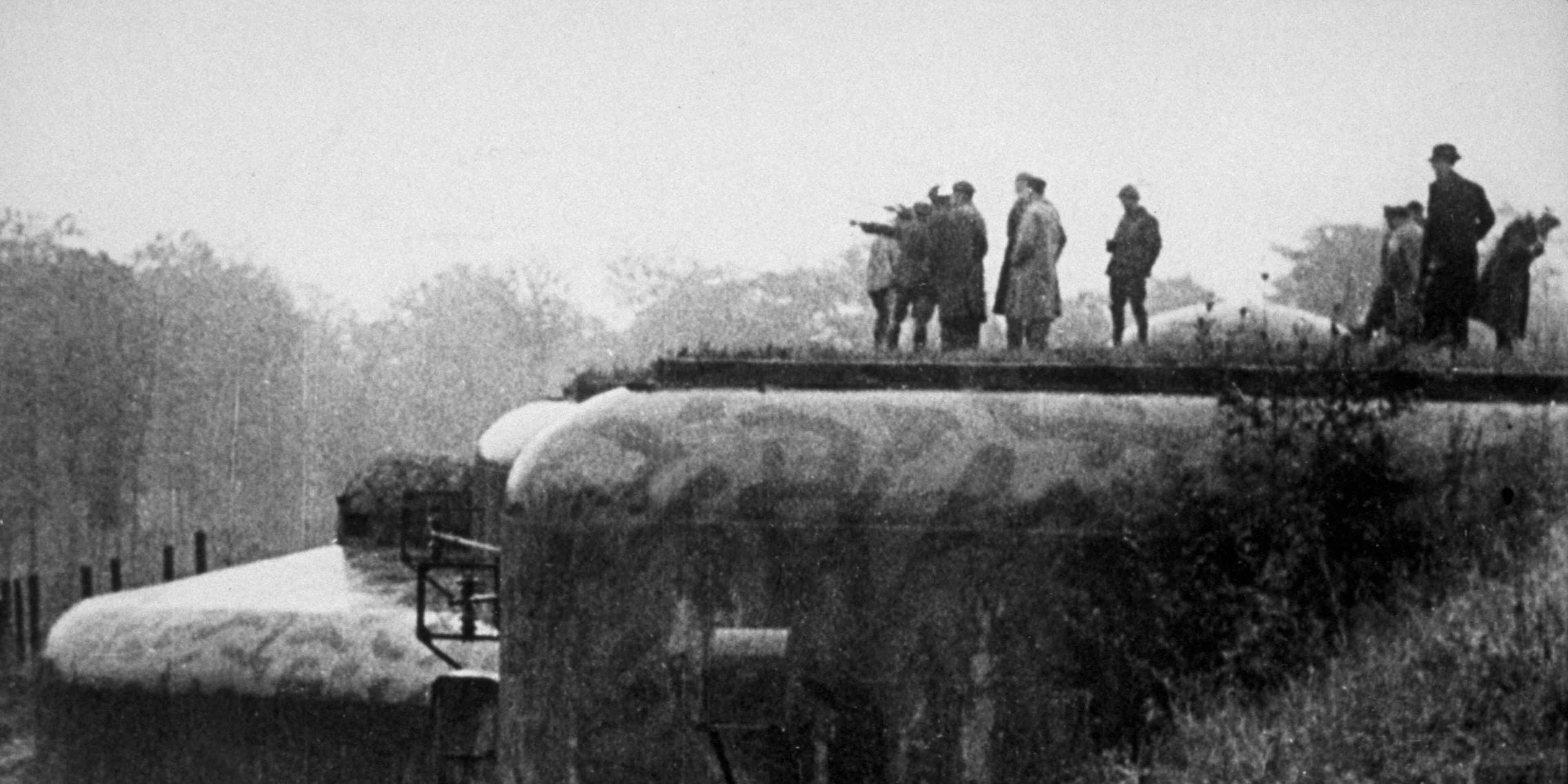 A French officer points in the direction of Berlin, from a fort on the Maginot Line, circa 1939.