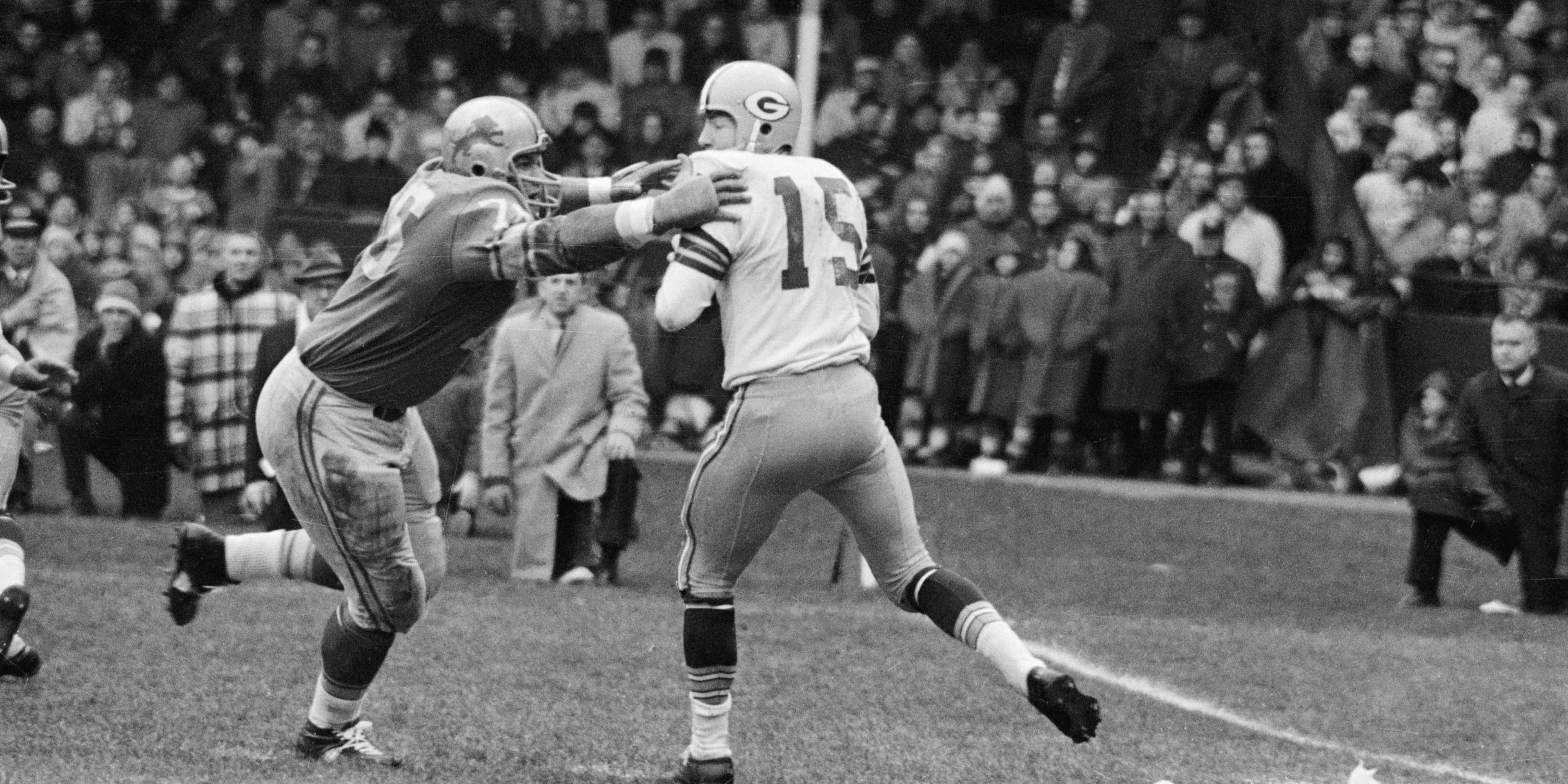 Roger Brown Goes After Bart Starr(Original Caption) 11/22/1962-Detroit, MI- Detroit Lions' Roger Brown (76) goes after Green Bay Packer quarterback Bart Starr (15), who was attempting a pass during the second quarter of the game with the Green Bay Packers November 22nd.