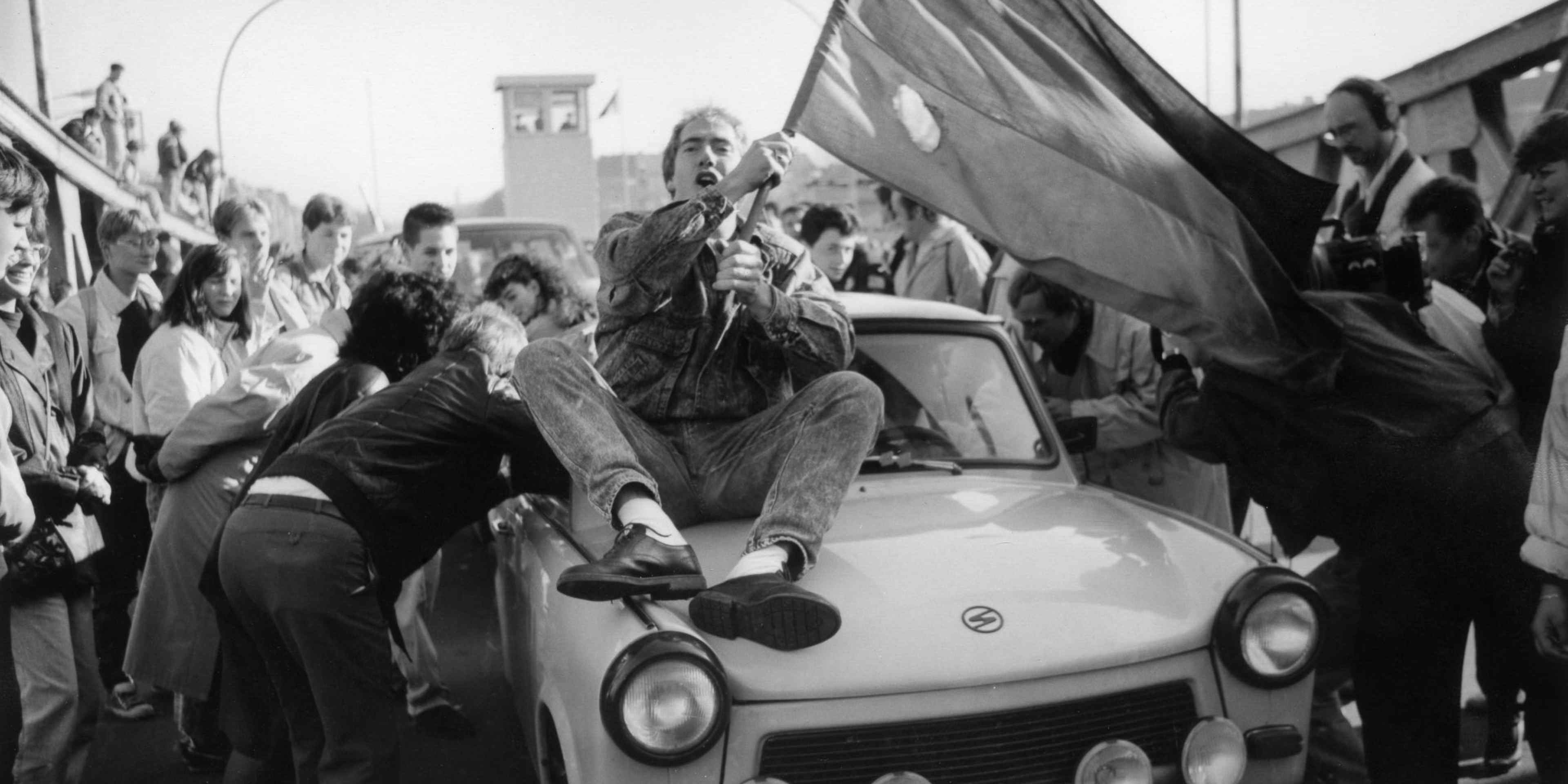 An excited crowd crossing the border at the Bornholm Bridge after the fall of the Berlin Wall.  (Credit: Brigitte Hiss/ullstein bild via Getty Images)