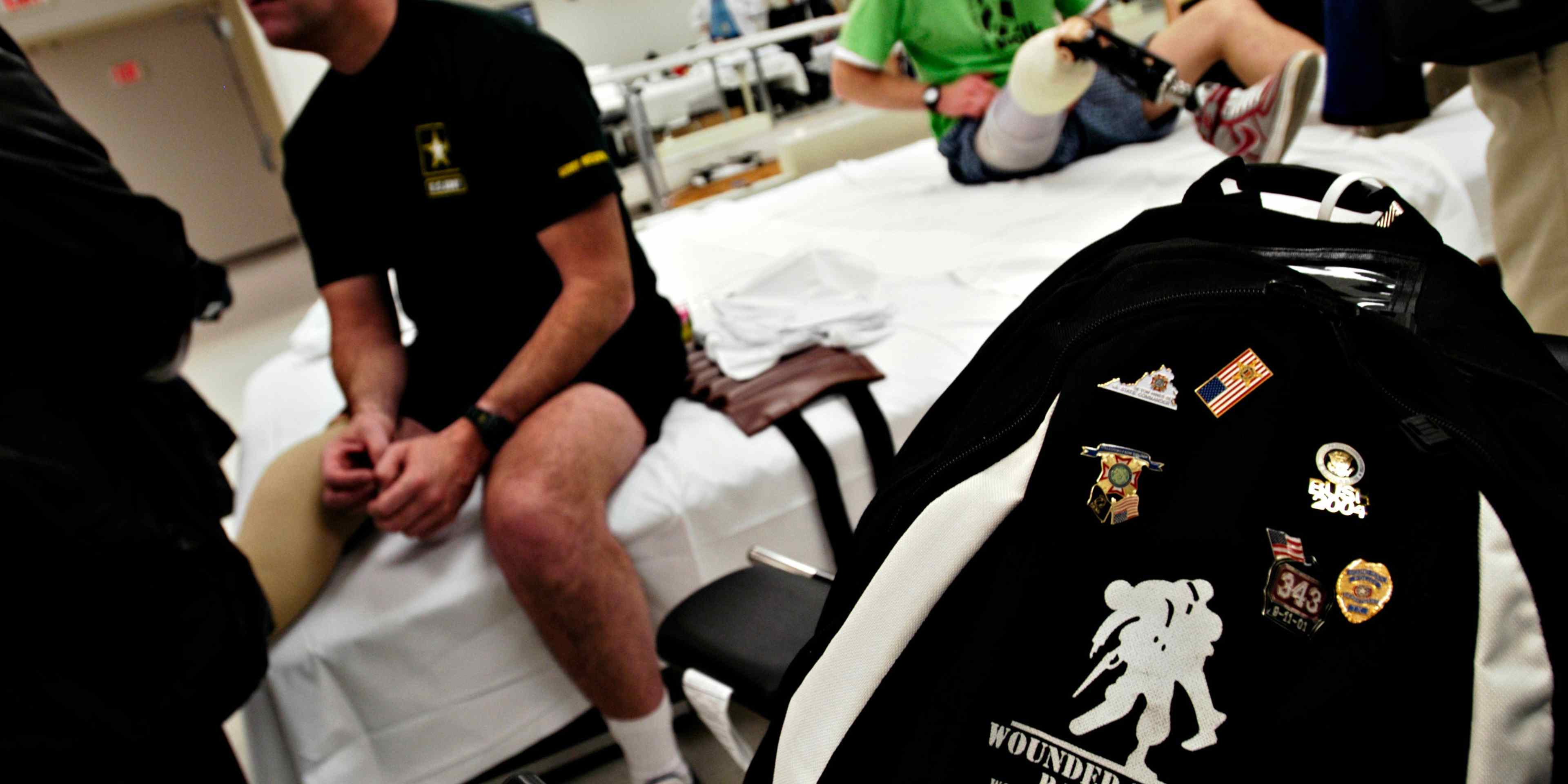 January 2005: Army Reserve Staff Sgt. Joe Bowser's "Wounded Warrior Project" backpack sits in the seat of his wheelchair in the physical therapy ward of Walter Reed Army Medical Center in Washington, D.C. as members of the Disabled American Veterans visit wounded soldiers who have recently returned from Iraq and are now receiving treatment.