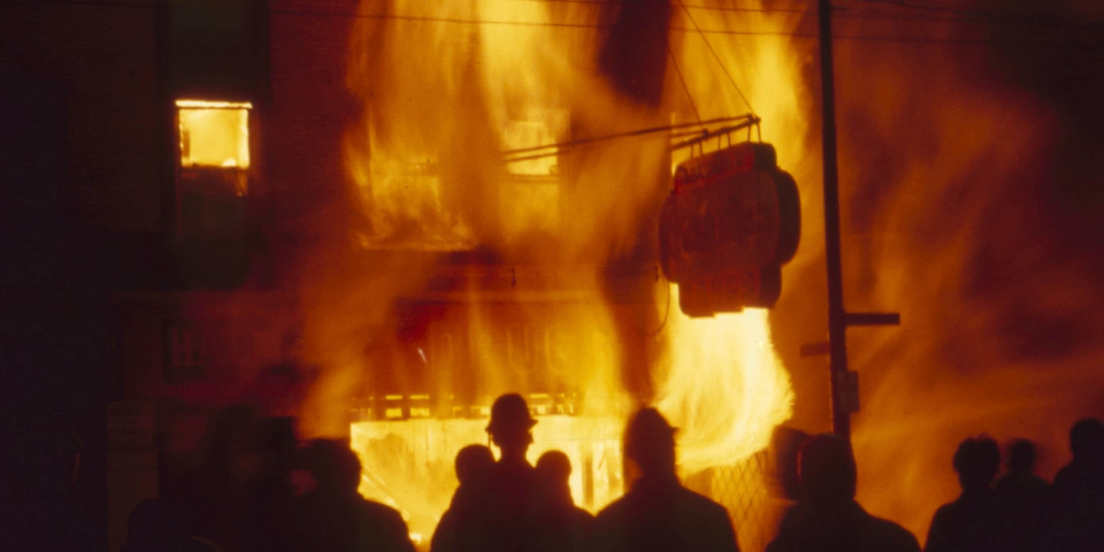 Onlookers watch as a Chicago storefront building burns during riots in the wake of Martin Luther King Jr's assassination, 1968. (Credit: Lee Balterman/The Life Picture Collection/Getty Images)