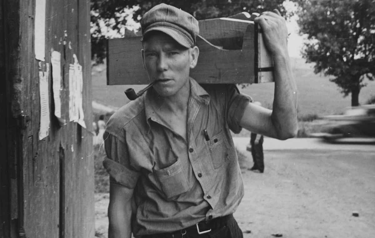 Carpenter, Depression EraBlack and white photograph of a carpenter, holding his toolbox on his shoulder, smoking a pipe, by Walker Evans, American photographer best known for his work for the Farm Security Administration documenting the effects of the Great Depression, as part of a fixed-term photographic campaign for the Resettlement Administration, Westmoreland County, Pennsylvania, 1935. From the New York Public Library. (Photo by Smith Collection/Gado/Getty Images).